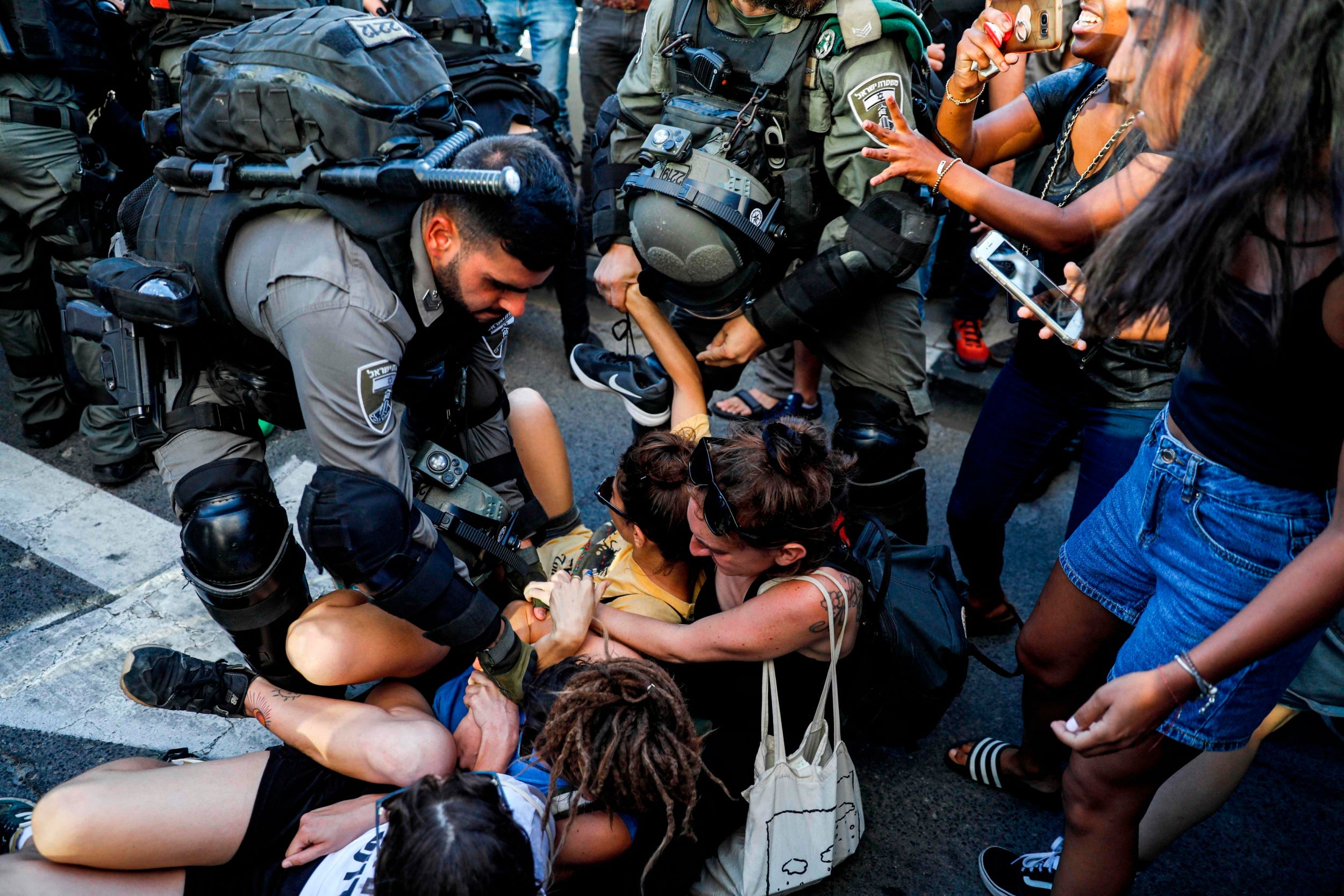 Members of the Israeli security forces detain a protester during a demonstration against killing of Solomon Teka