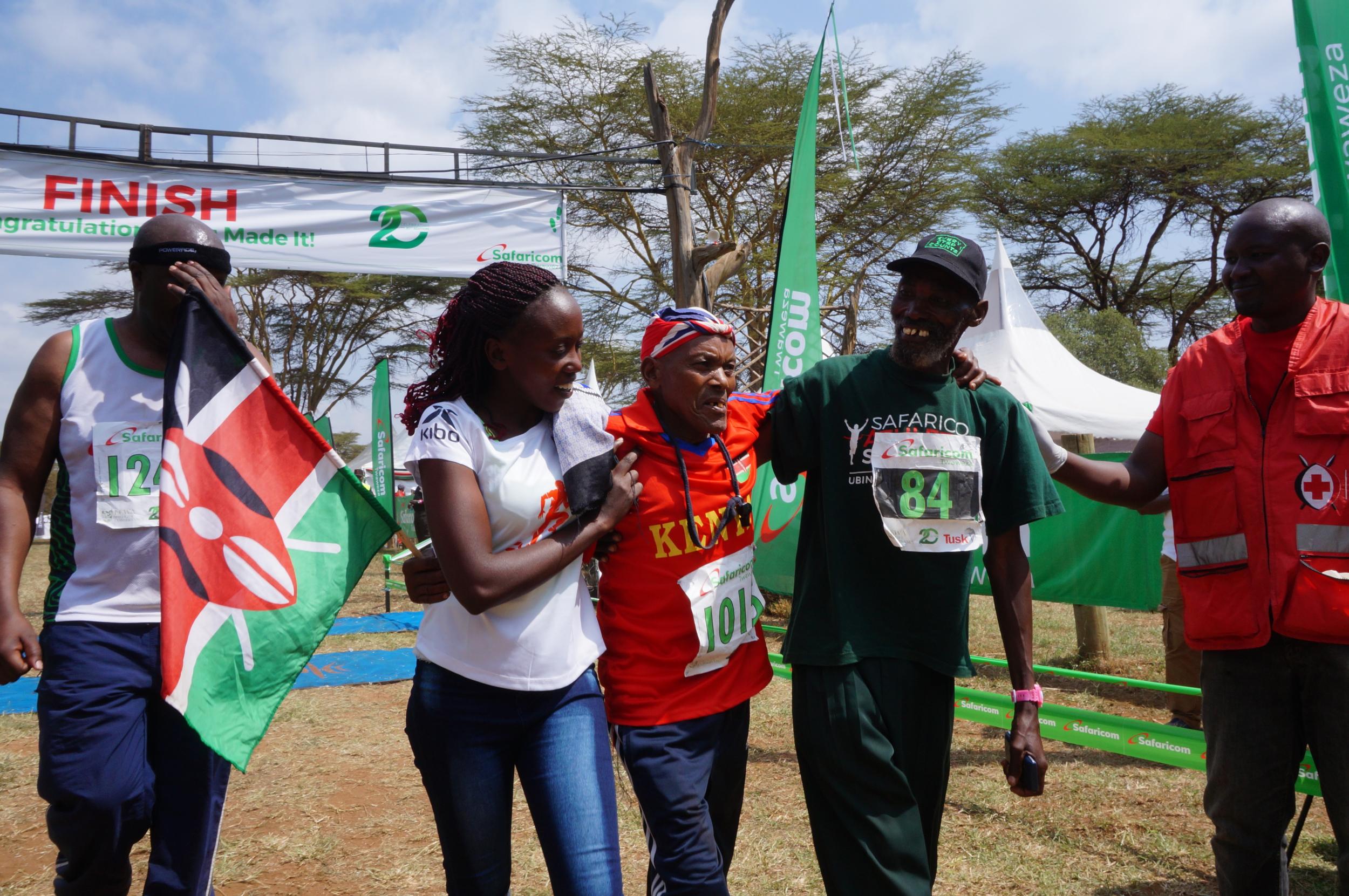 John Ruengo (centre) celebrates at the finish line with his children