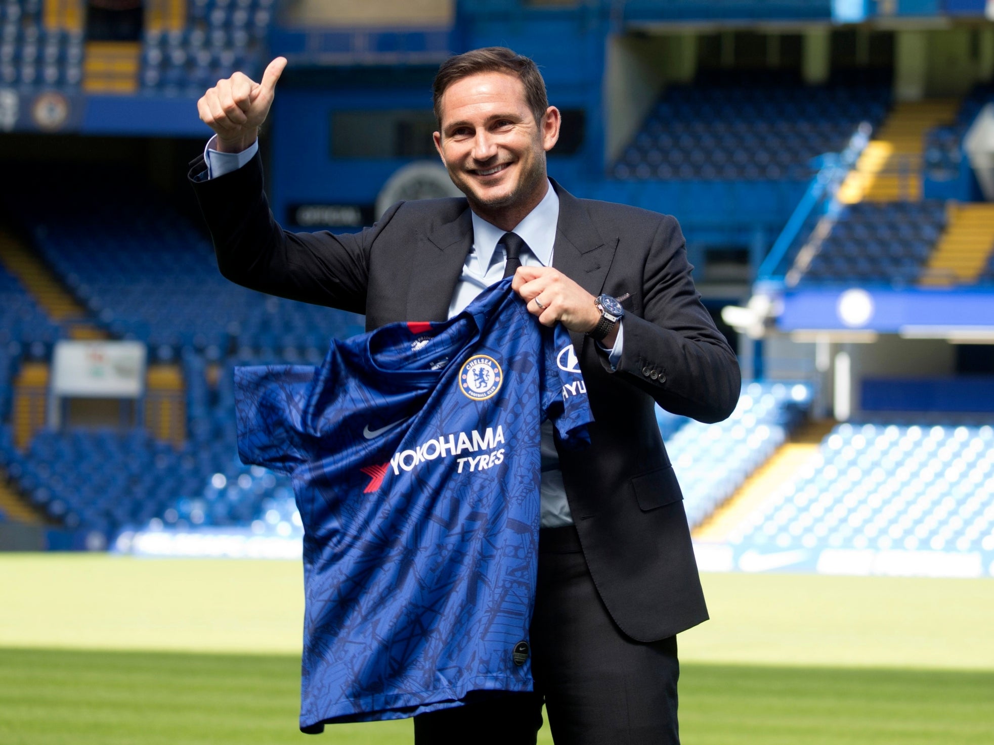 Lampard poses with a Chelsea shirt after his appointment is confirmed