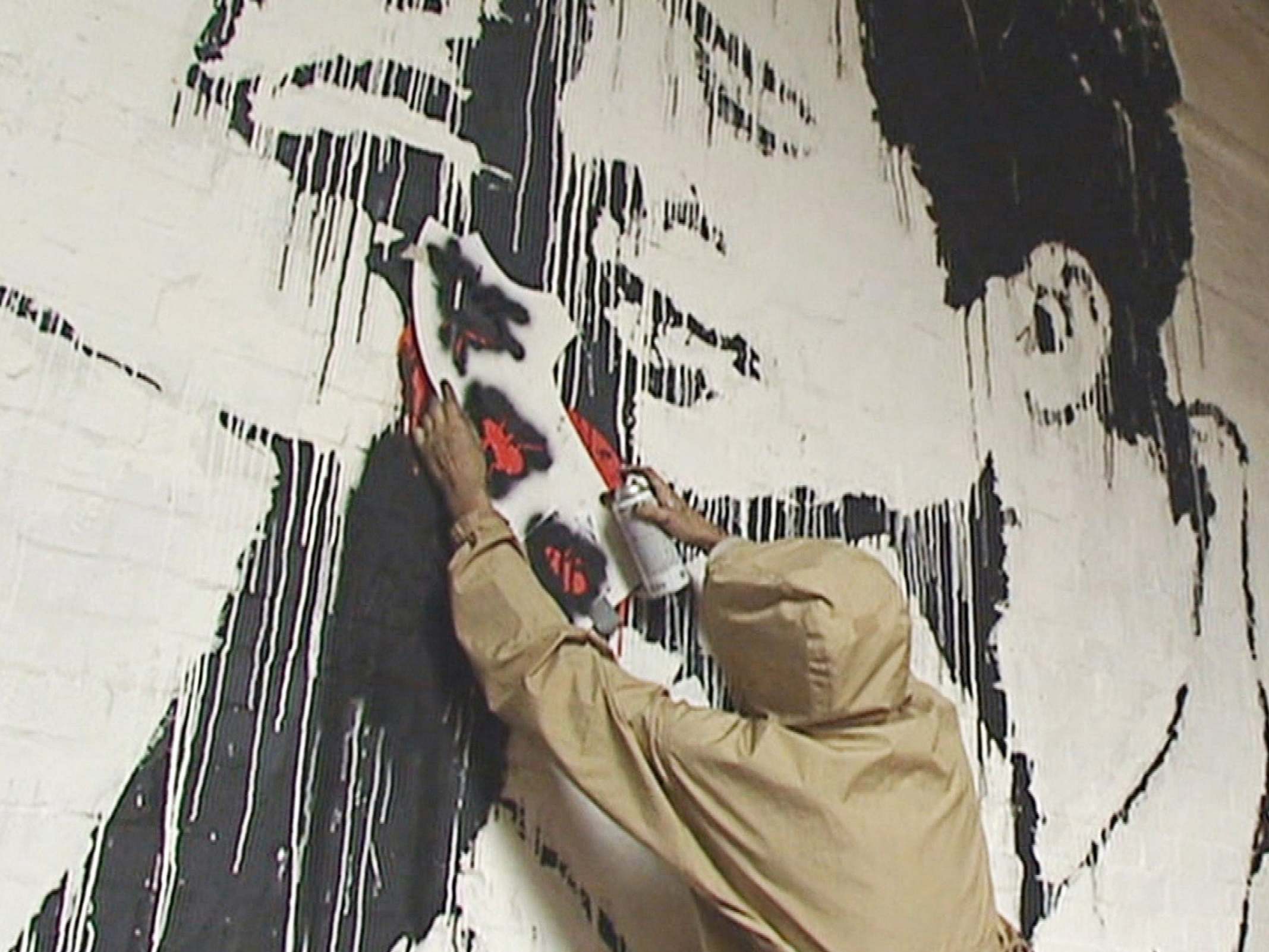 A young man claiming to be Banksy works on a piece since attributed to the mysterious artist during a recently uncovered ITV interview from 2003