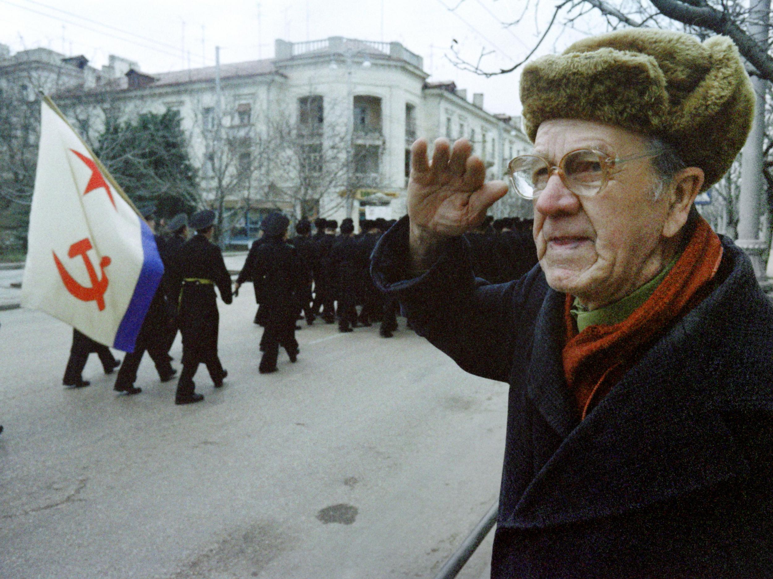 A Russian man salutes sailors from the CIS Black Sea, in 1992