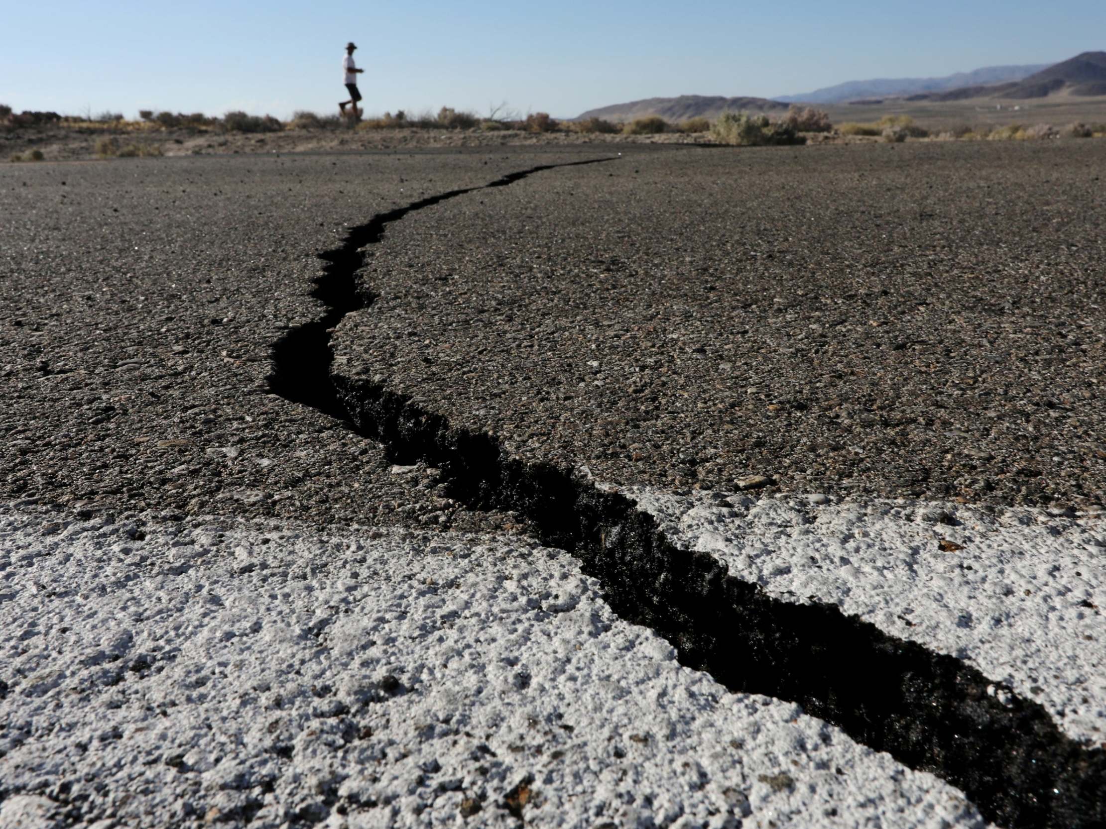 Fissures that opened up under a highway during a powerful earthquake that struck Southern California are seen near the city of Ridgecrest