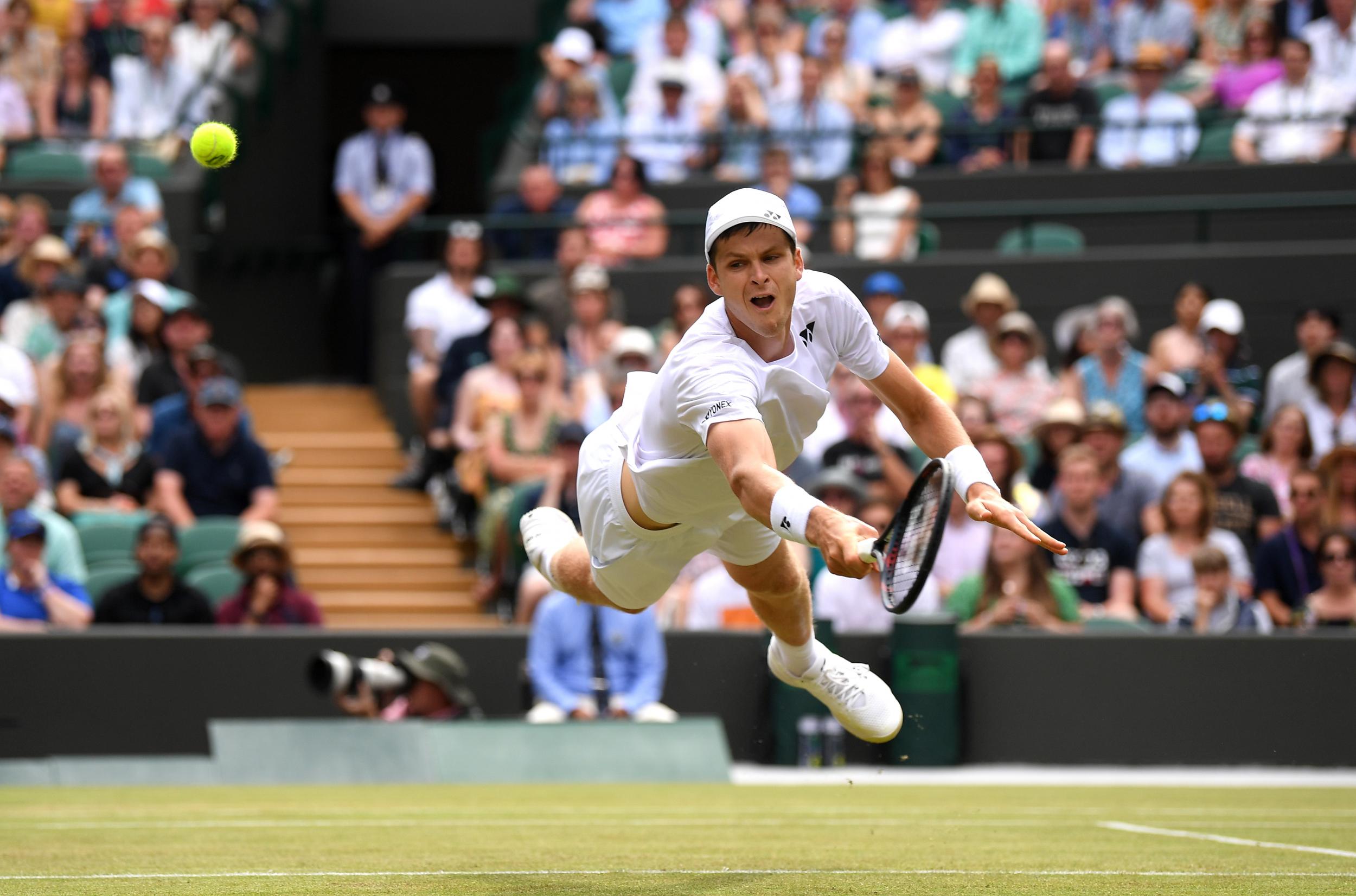 Hubert Hurkacz in mid-air during his third round match against Novak Djokovic