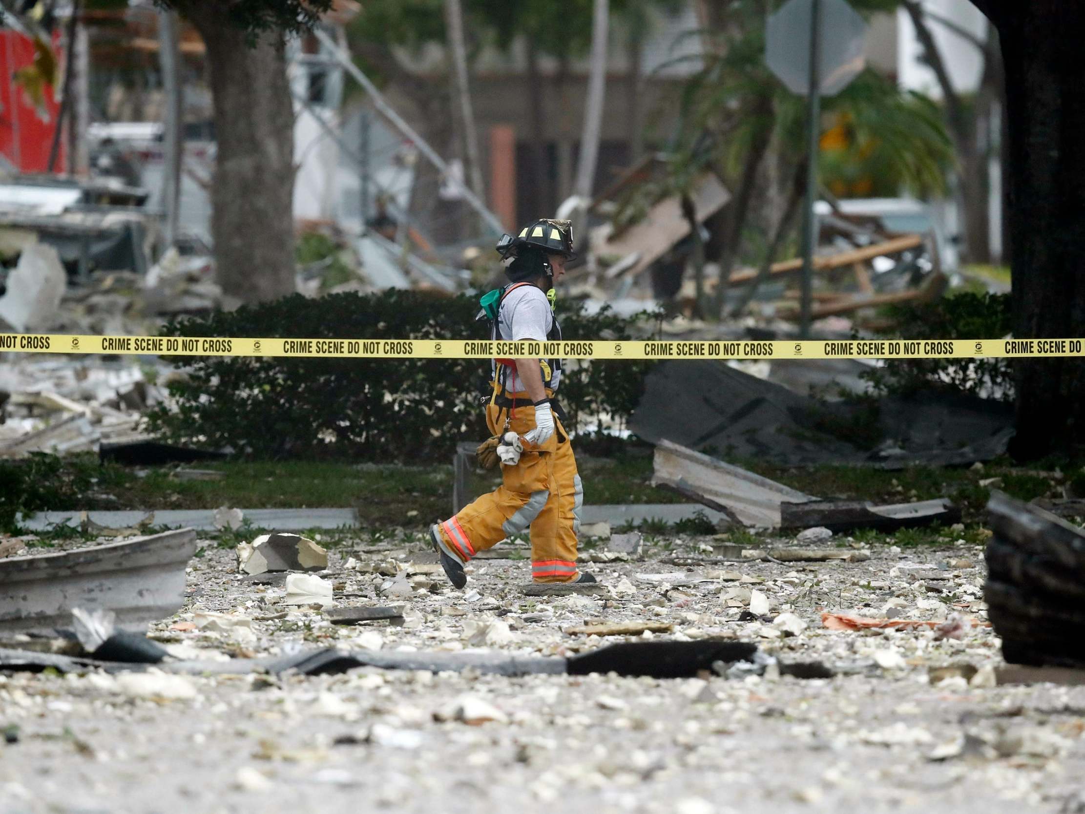 A firefighter walks through the remains of a building after an explosion in Plantation, Florida