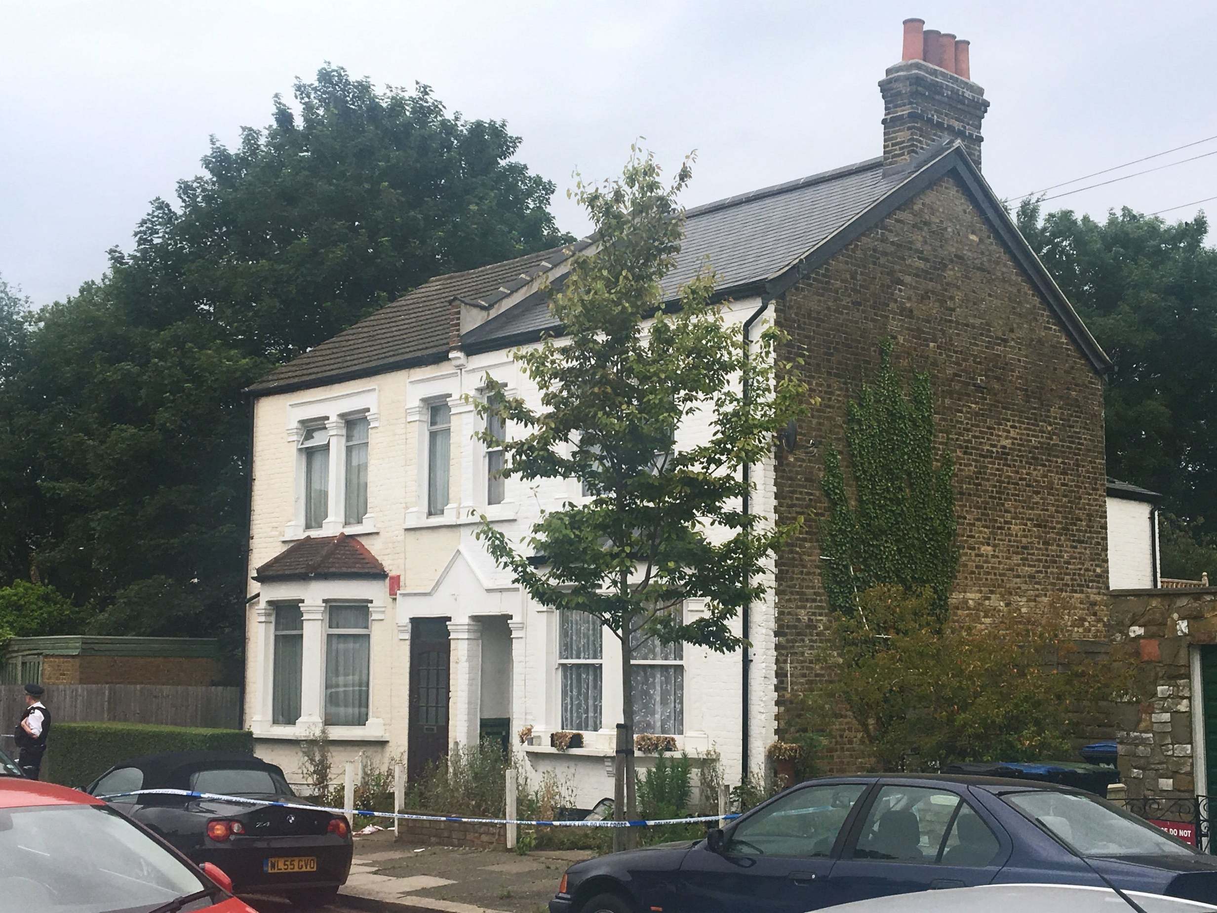 Police at a house on Livingstone Road in Enfield where stabbings took place