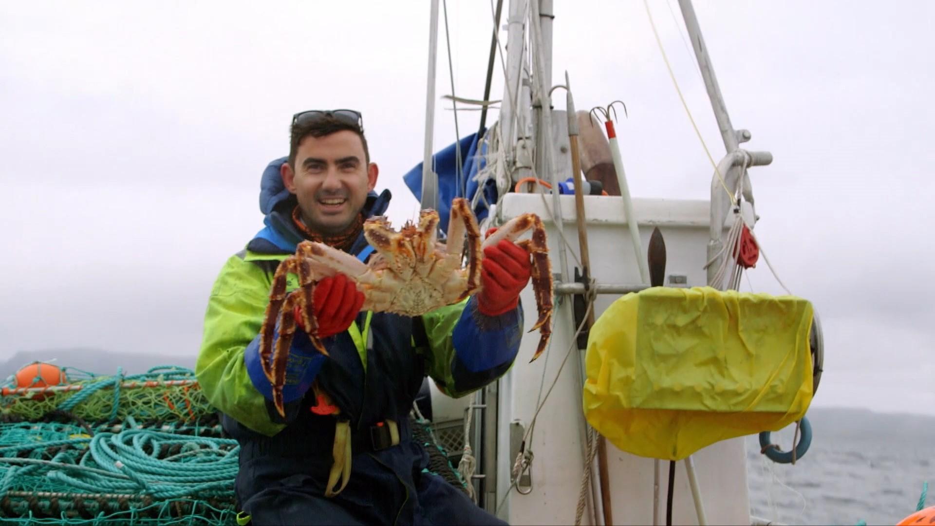 Simon Parker holding a king crab – their leg span can grow to 6ft