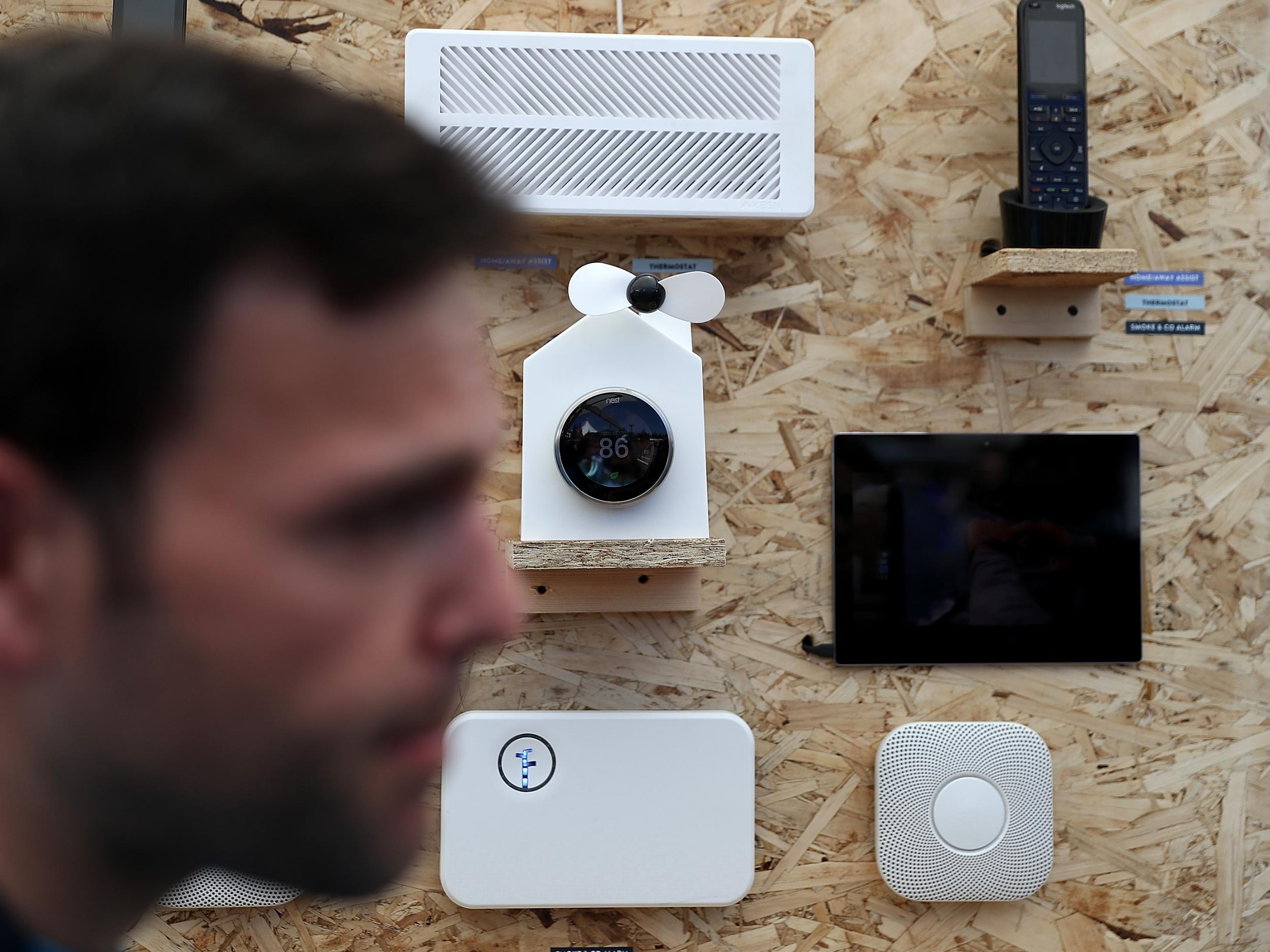 An attendee passes a display of Nest products during Google I/O 2016 at Shoreline Amphitheatre on 19 May, 2016 in Mountain View, California