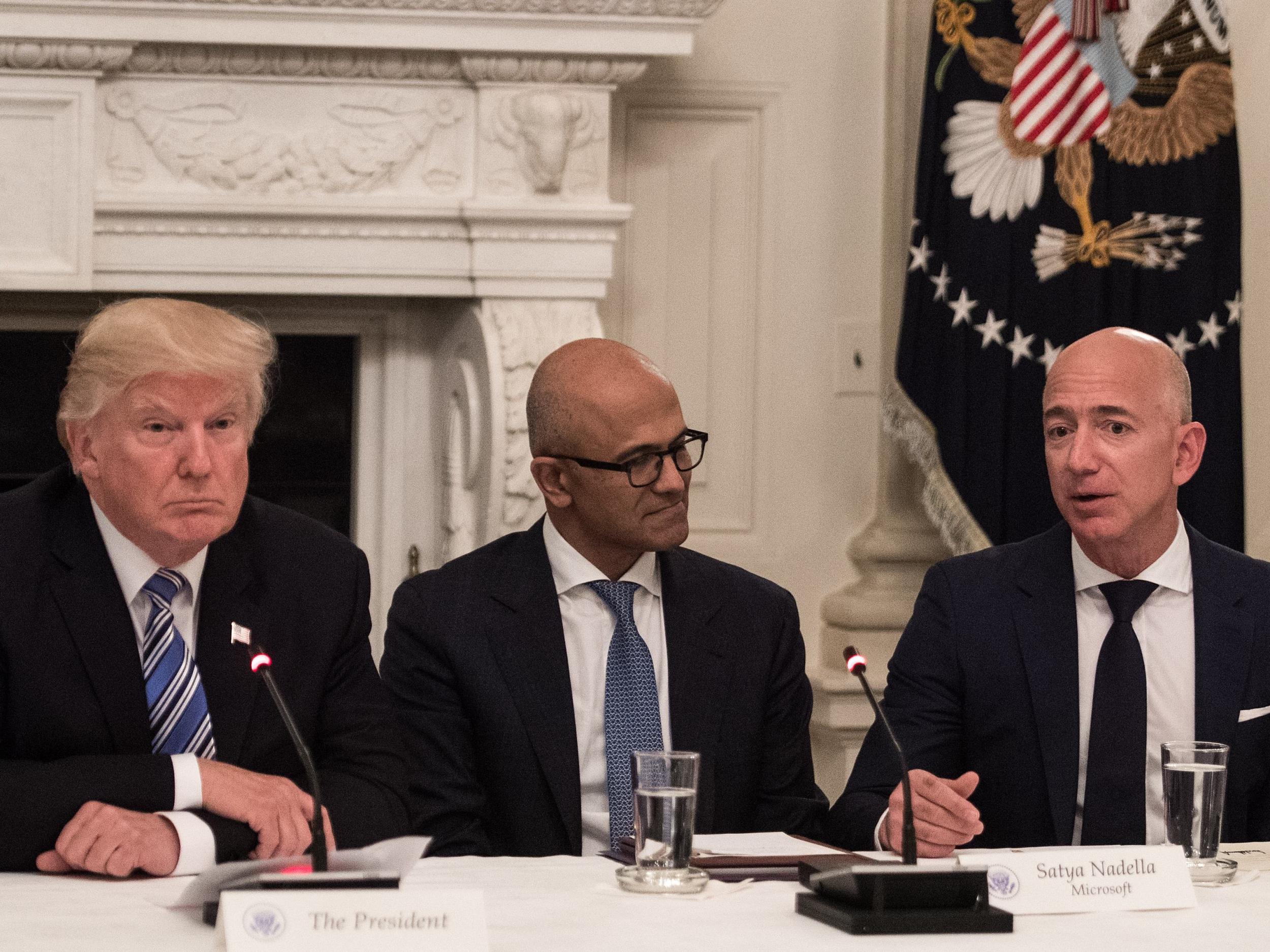 US President Donald Trump and Microsoft CEO Satya Nadella listen to Amazon CEO Jeff Bezos during an American Technology Council roundtable at the White House in Washington, DC, on 19 June 19, 2017