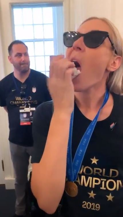 Allie Long shoves piece of paper in her mouth at City Hall