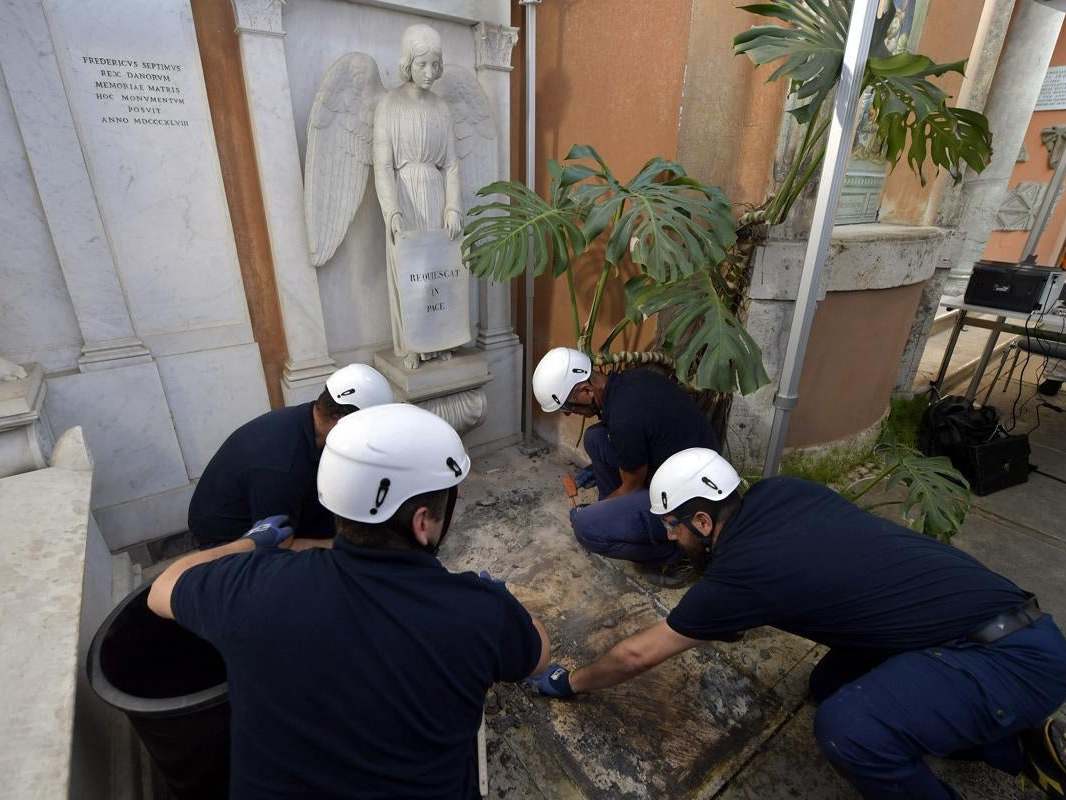 A handout picture provided by the Vatican Media shows the opening of two tombs at the Teutonic Cemetery