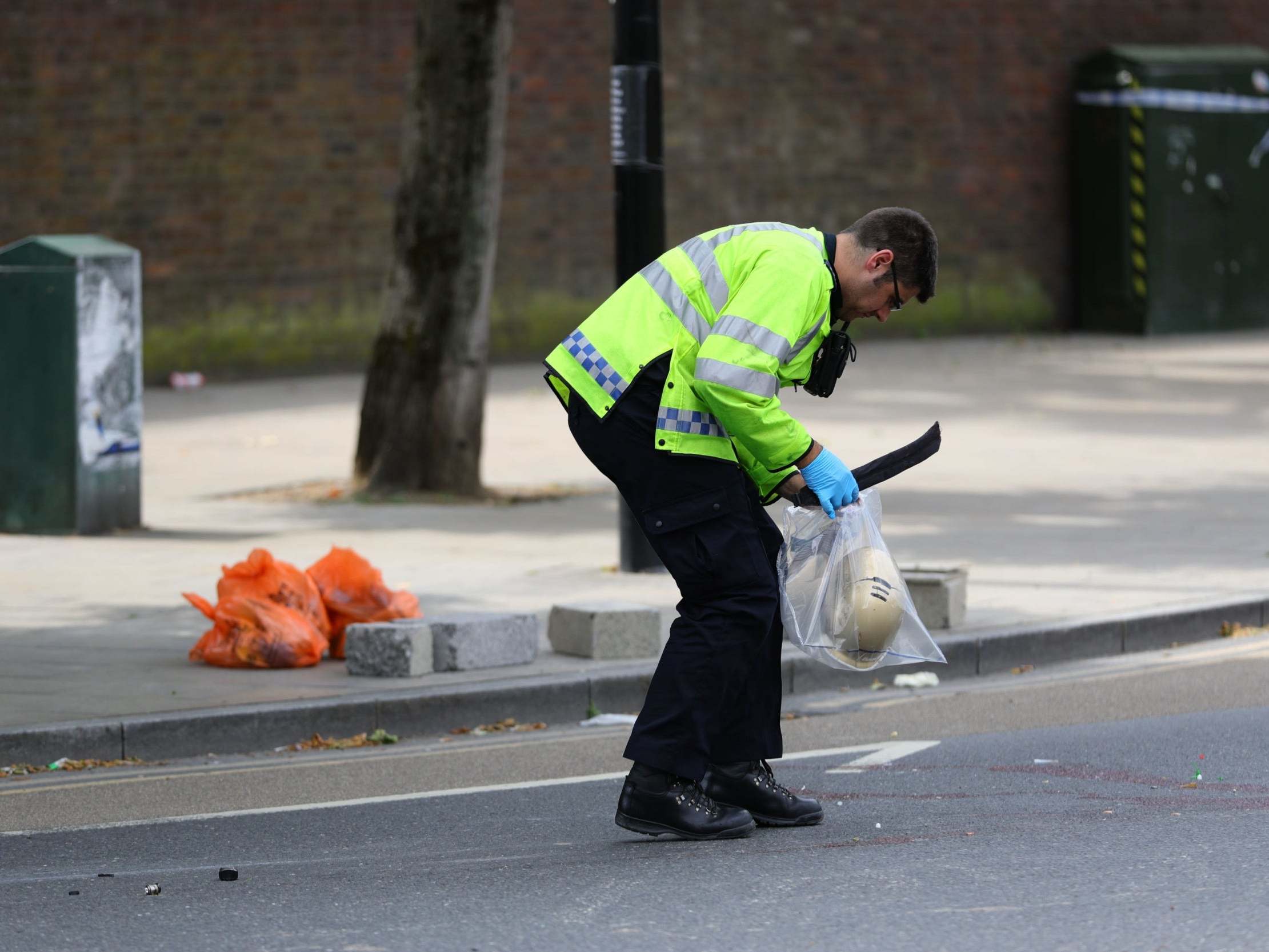 Police at the scene in Battersea, where woman died after being struck by a lorry