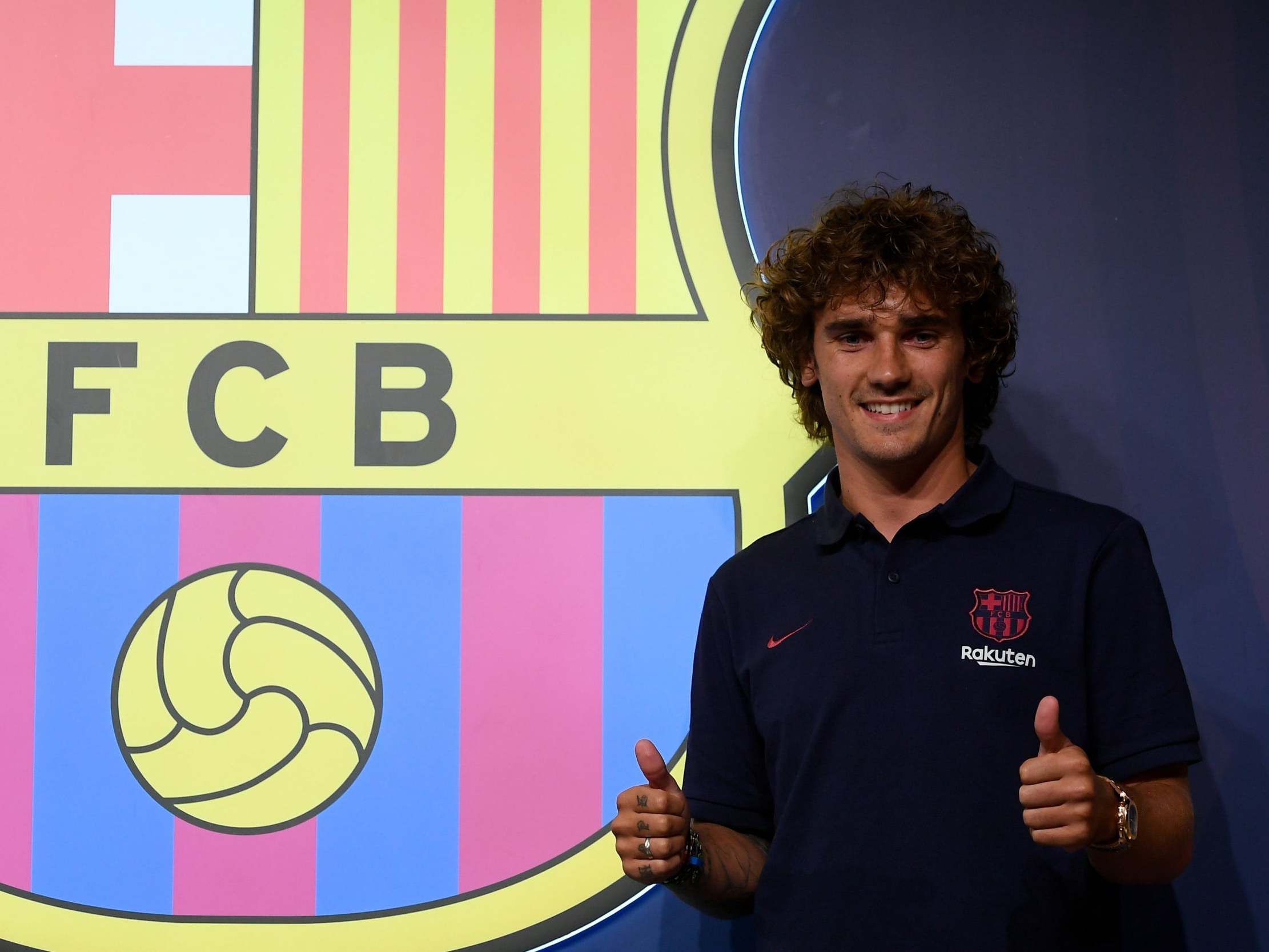 Griezmann poses after signing for Barcelona