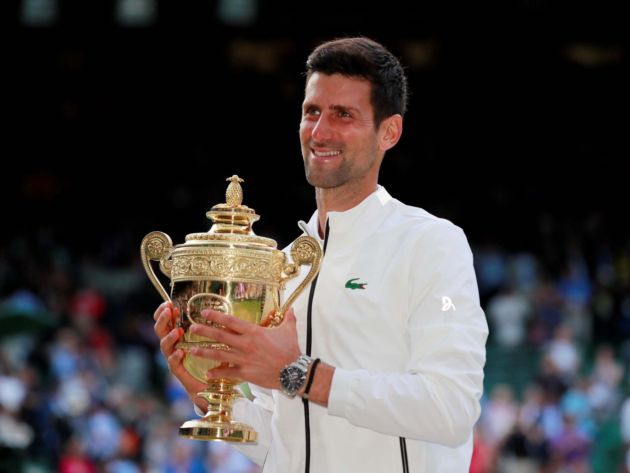 Djokovic poses with the trophy (REUTERS)