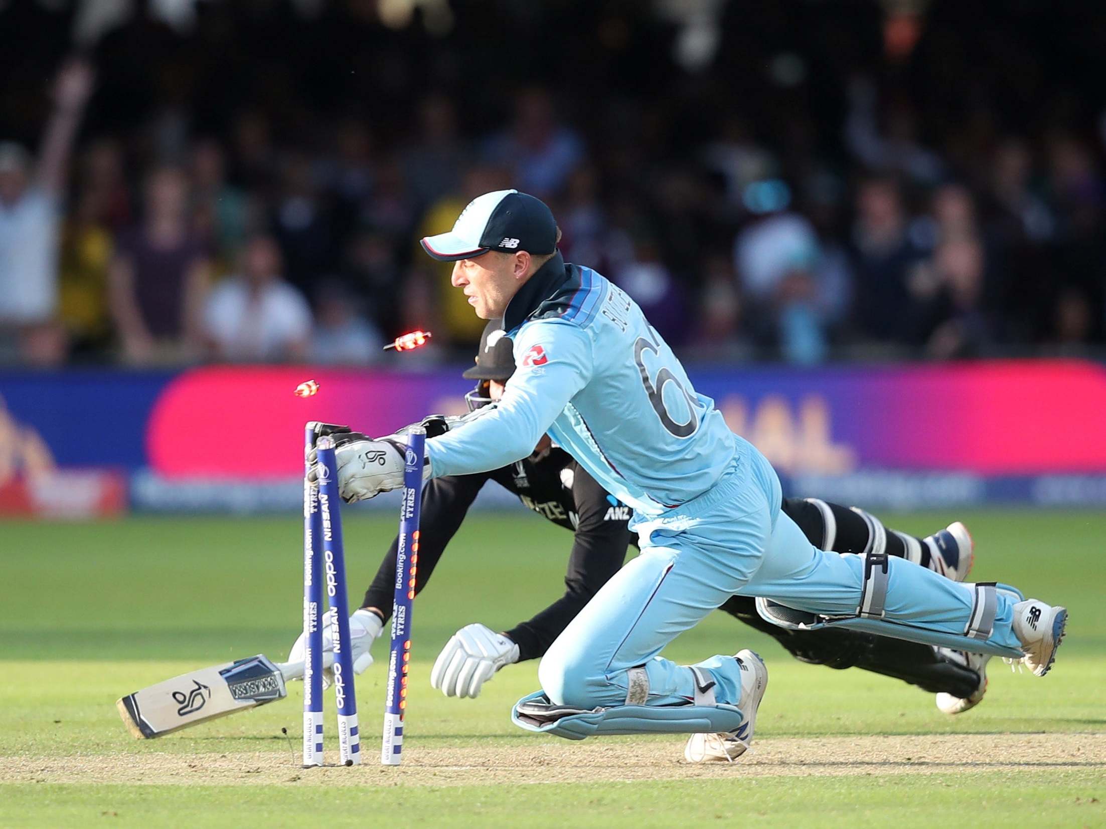 Jos Buttler sweeps away the bails to win the World Cup