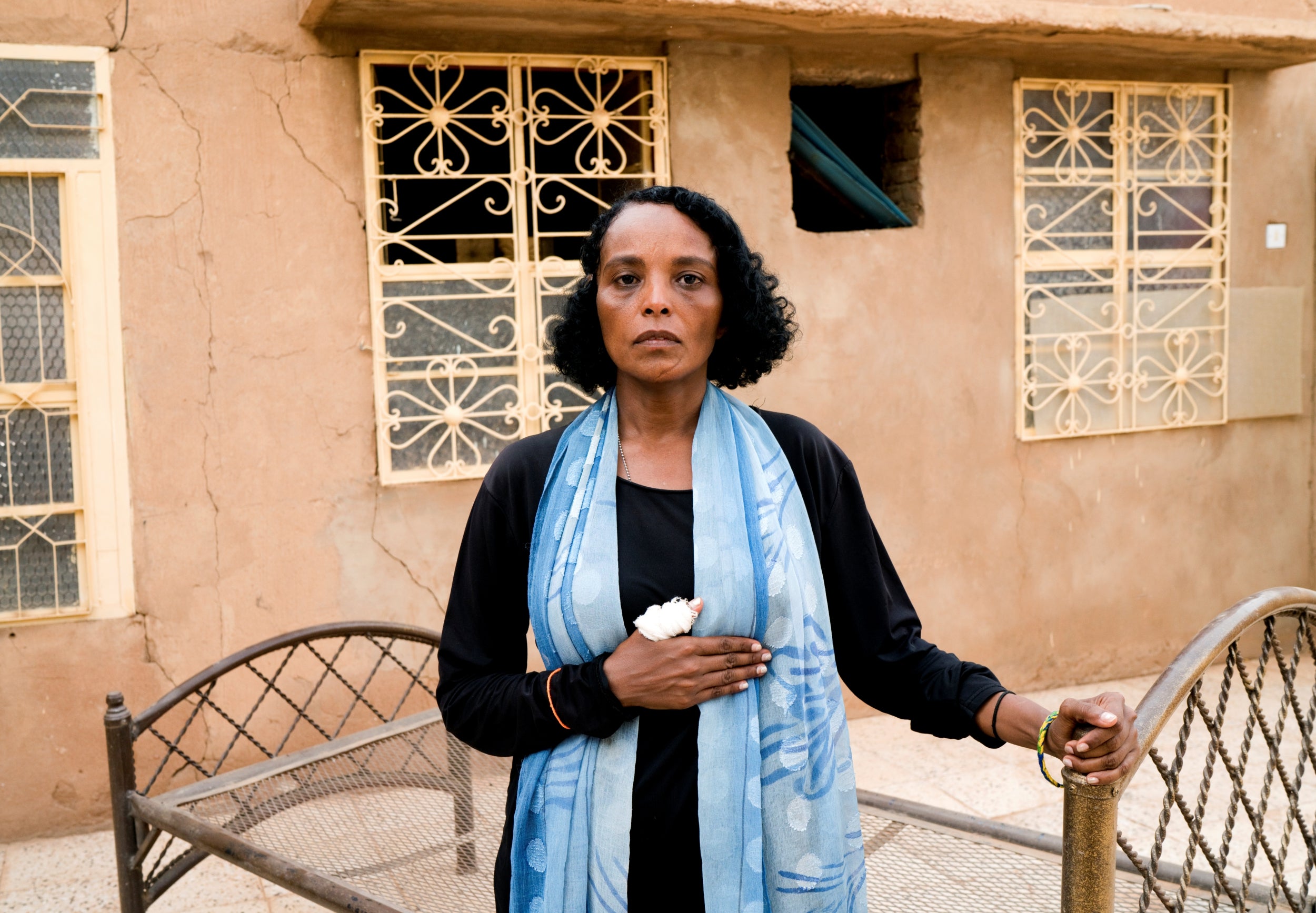 Khadija Saleh, 41, a political activist and blogger, poses for a photograph in Khartoum, Sudan. After six years abroad, Saleh returned to her home country when people took to the streets demanding change. She was at a sit-in near the defence ministry in Khartoum on 3 June when security forces stormed the site. The area had become a centre for anti-government protests. Saleh said she was beaten with sticks, and still wears bandages on her wounds. ‘I came back from a safer place because I want a better future for this country,’ she said.