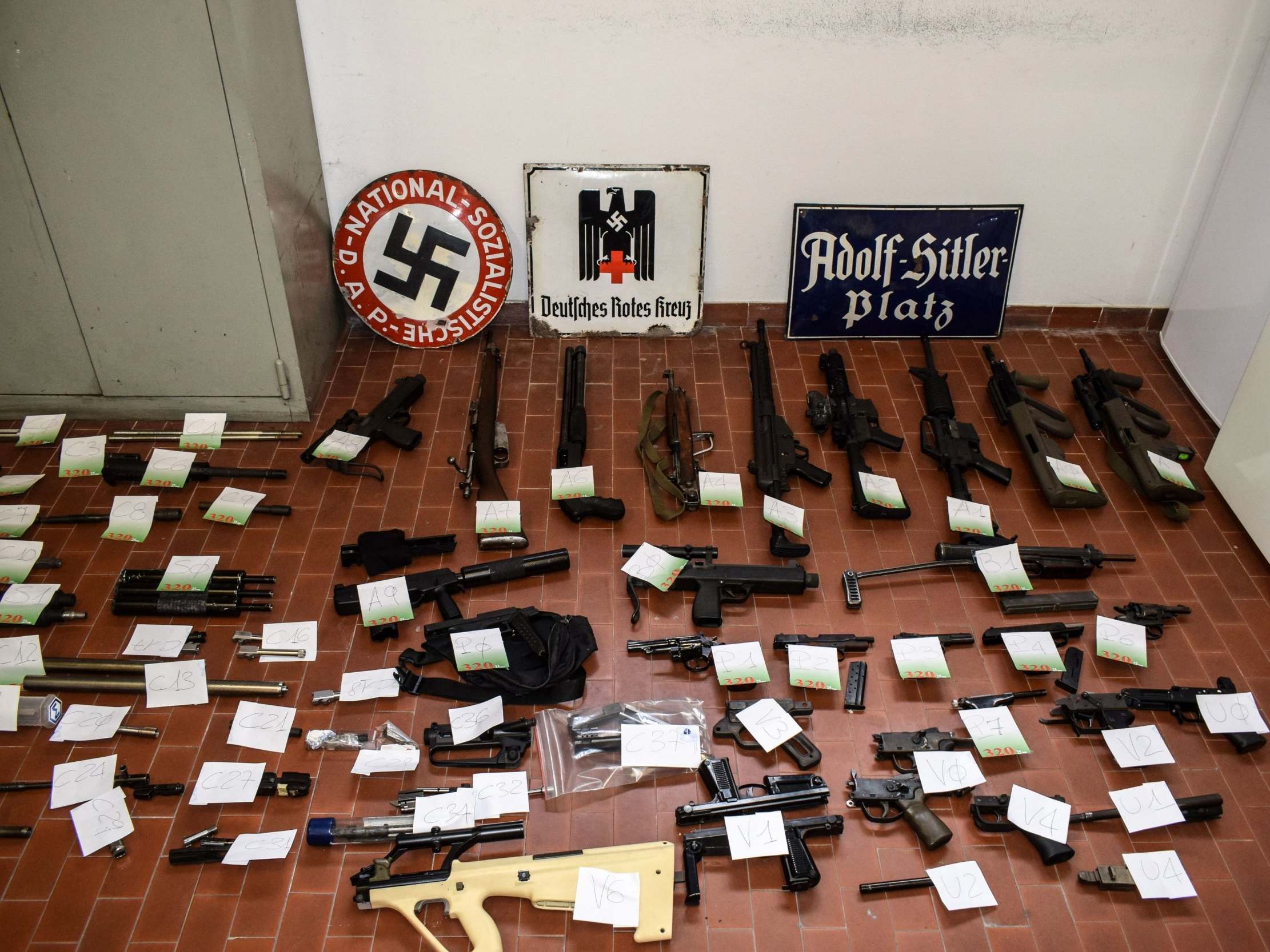 A large cache of guns and ammunition was seized by the Turin special police force, along with Nazi plaques