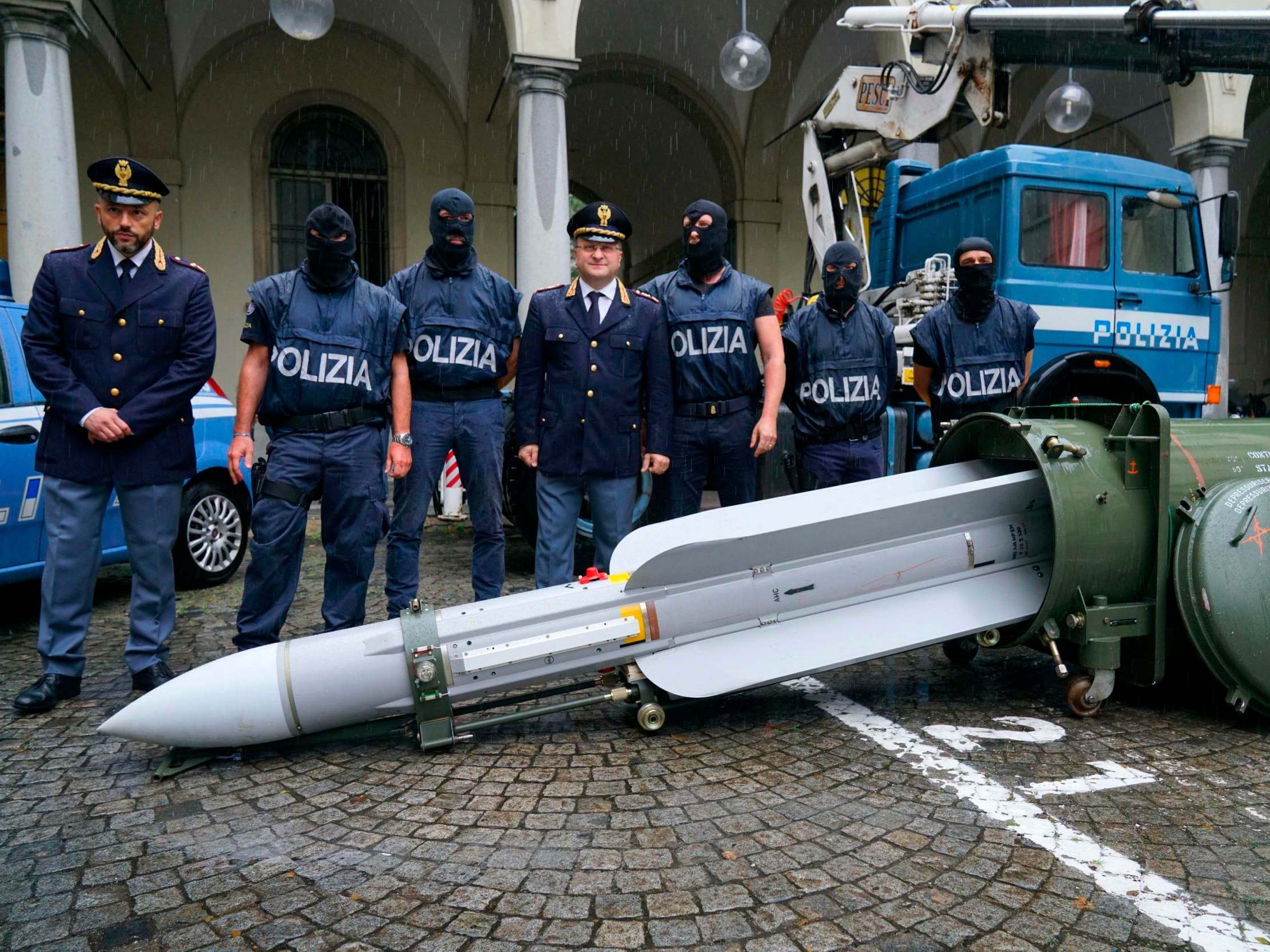 Police stand by a missile seized at an airport hangar near Pavia, northern Italy (Tino Romano/ANSA via AP)