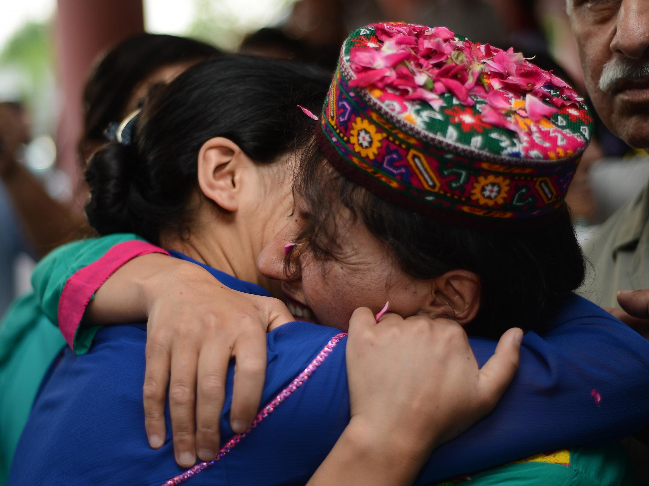 Samina Baig (right) greets a supporter as she arrives in Islamabad after completing Everest in 2013