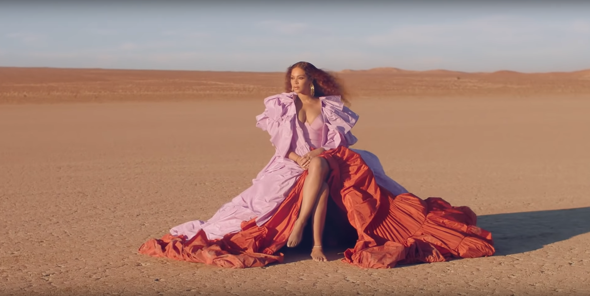 Beyoncé is first seen in the 'Spirit' music video wearing a pink and red ruffled gown, a possible homage to the iconic sunset with which the video and <i>The Lion King</i> both open.