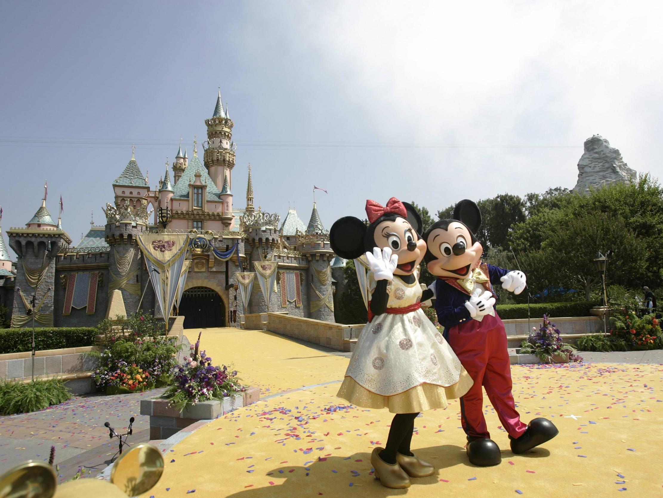 Disney characters Mickey Mouse and Minnie in front of the Sleeping Beauty Castle at Disneyland in Anaheim, California.