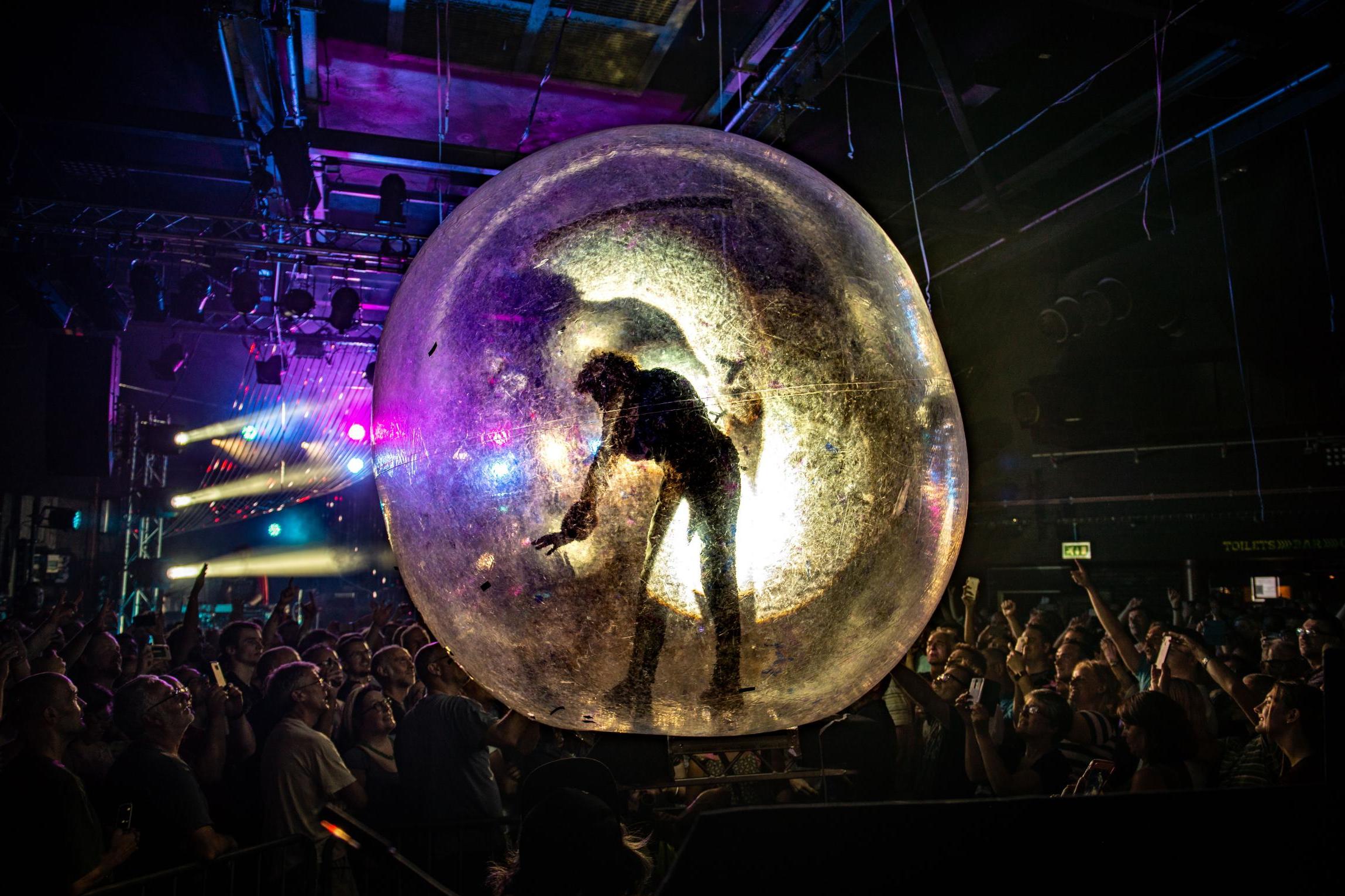 Wayne Coyne rolls across the Cambridge Junction crowd in a giant plastic ball in 2018