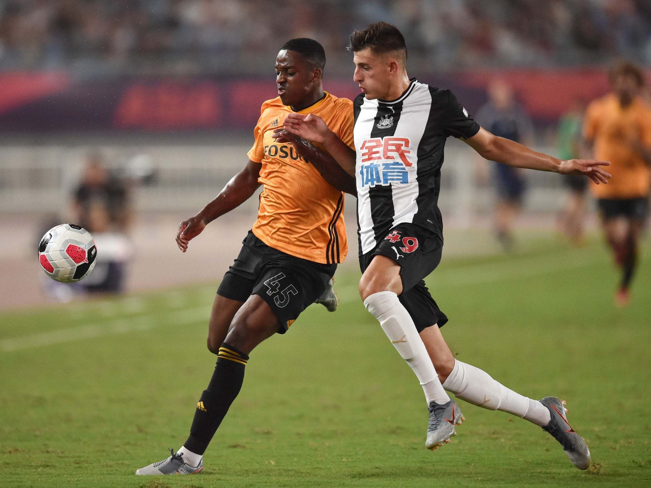 Newcastle United's Kelland Watts, right, fights for the ball