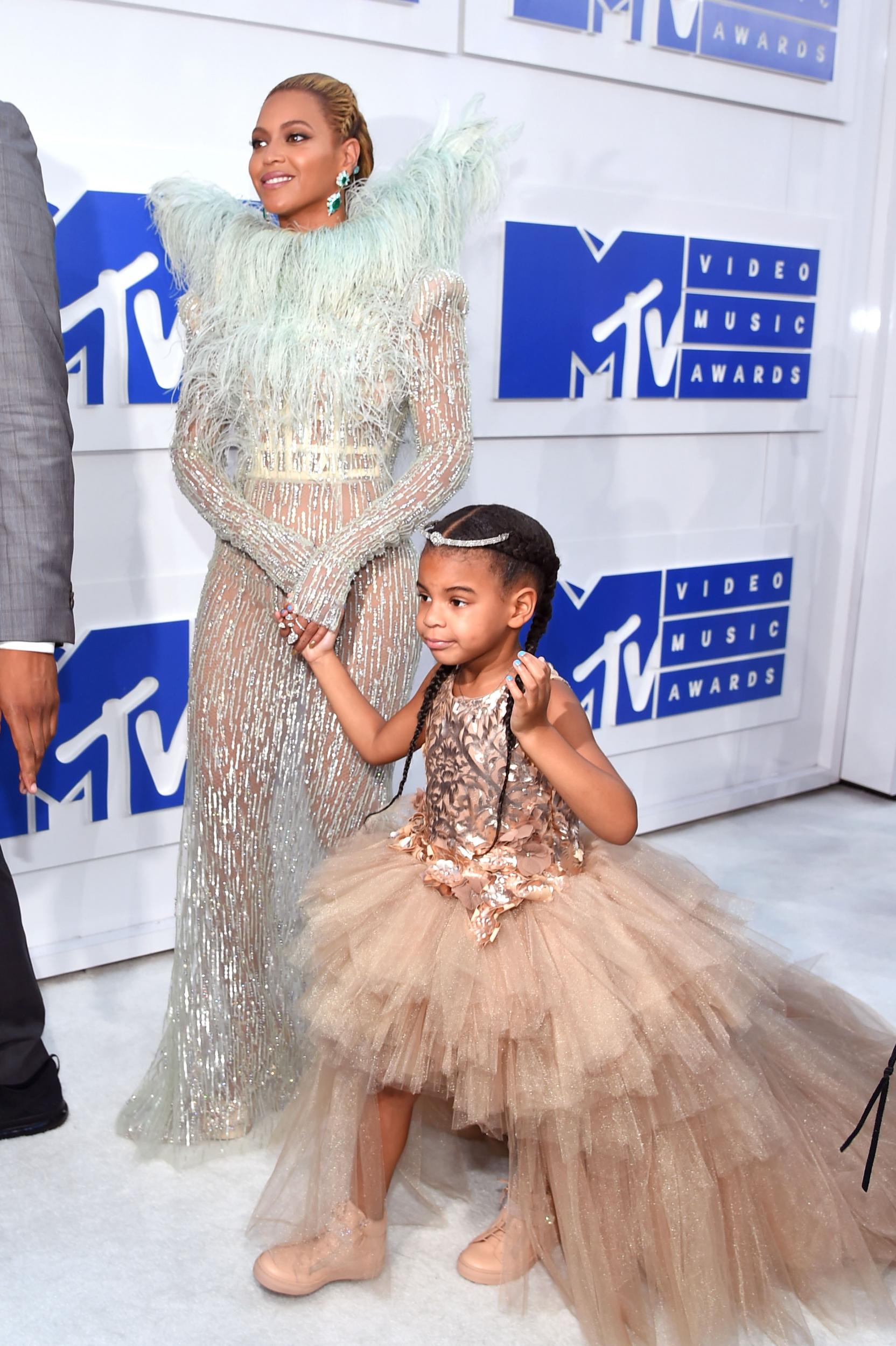 Beyoncé and Blue Ivy were the epitome of elegance at the 2016 MTV Video Music Awards, walking hand-in-hand on the white carpet. The singer's feathered and beaded gown was created by couture designer Francesca Scognamiglio, while Blue Ivy wore a ruffled dress by haute couture childrenswear designer Mischka Aoki.