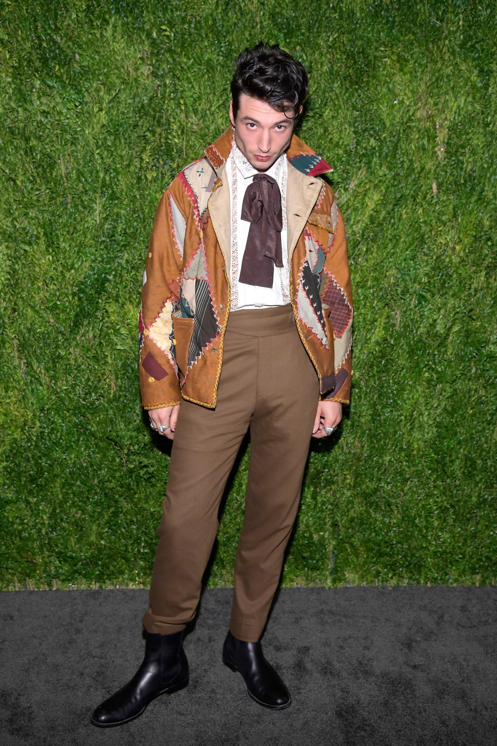The actor almost always turns heads in his stylish garb. When he's not masking his face and fancying himself as a sartorial optical illusion (see his 2019 Met Gala look), he's donning cigarette trousers and finely cut shirts, often with some sort of eccentric twist. For his appearance at the CFDA/Vogue Fashion Fund anniversary event, that twist is an oversized chocolate brown neck tie that serves no practical purpose whatsoever, which is exactly the point.