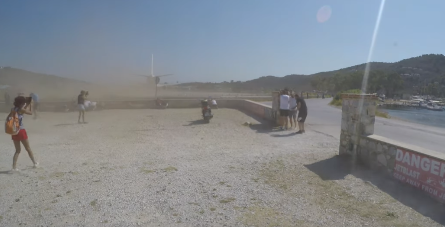 A departing plane kicks up a cloud of dust at Skiathos airport