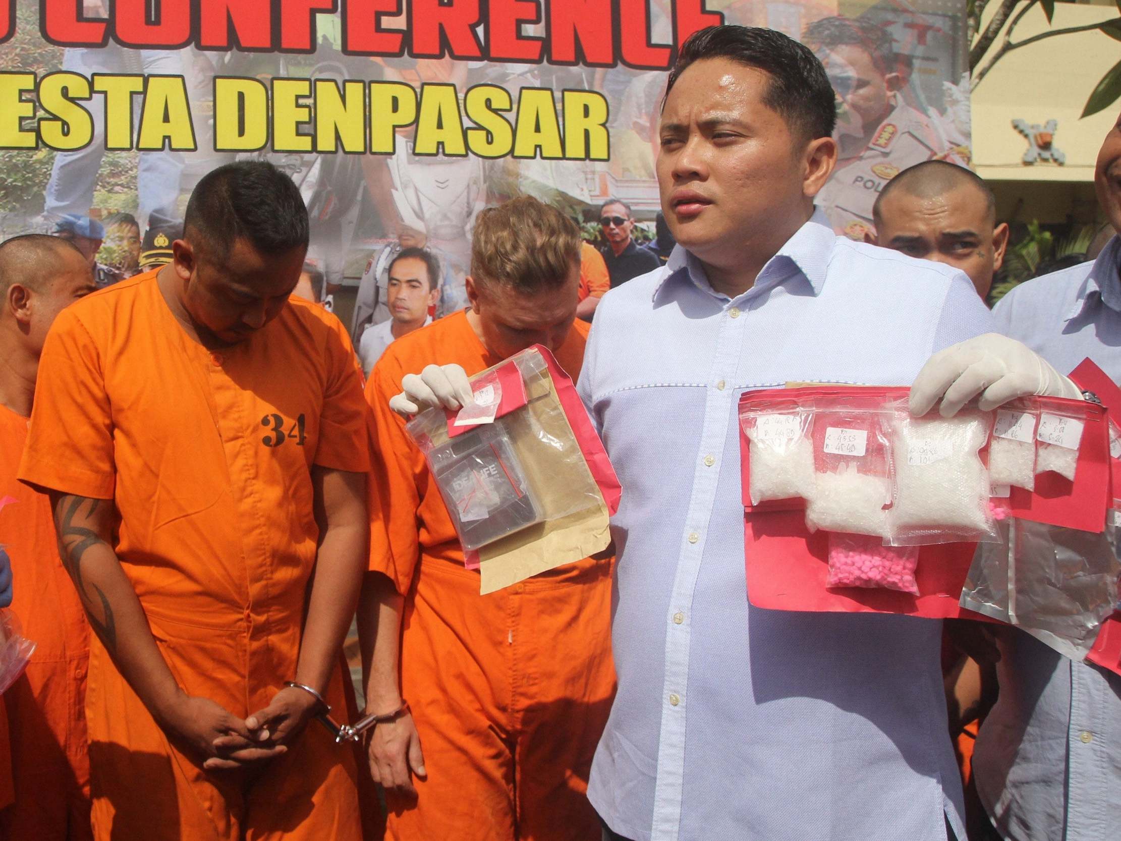 Australians William Cabantog (left) and David Van Iersel (centre) appear during a press conference in Denpasar, Bali, on 23 July 2019 after being arrested for alleged cocaine possession.