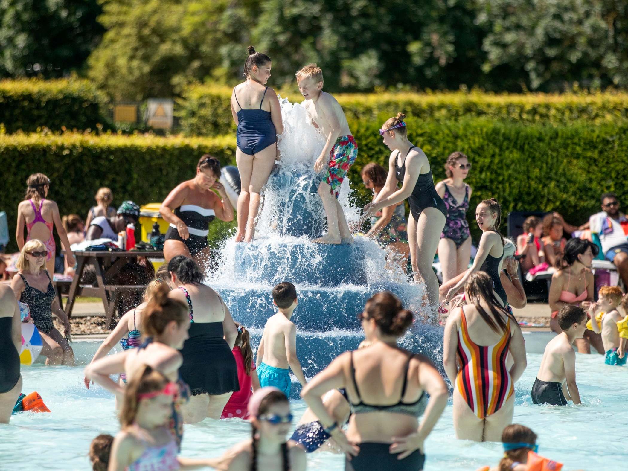 Swimmers enjoy the sun at Ilkley outdoor pool and lido in West Yorkshire