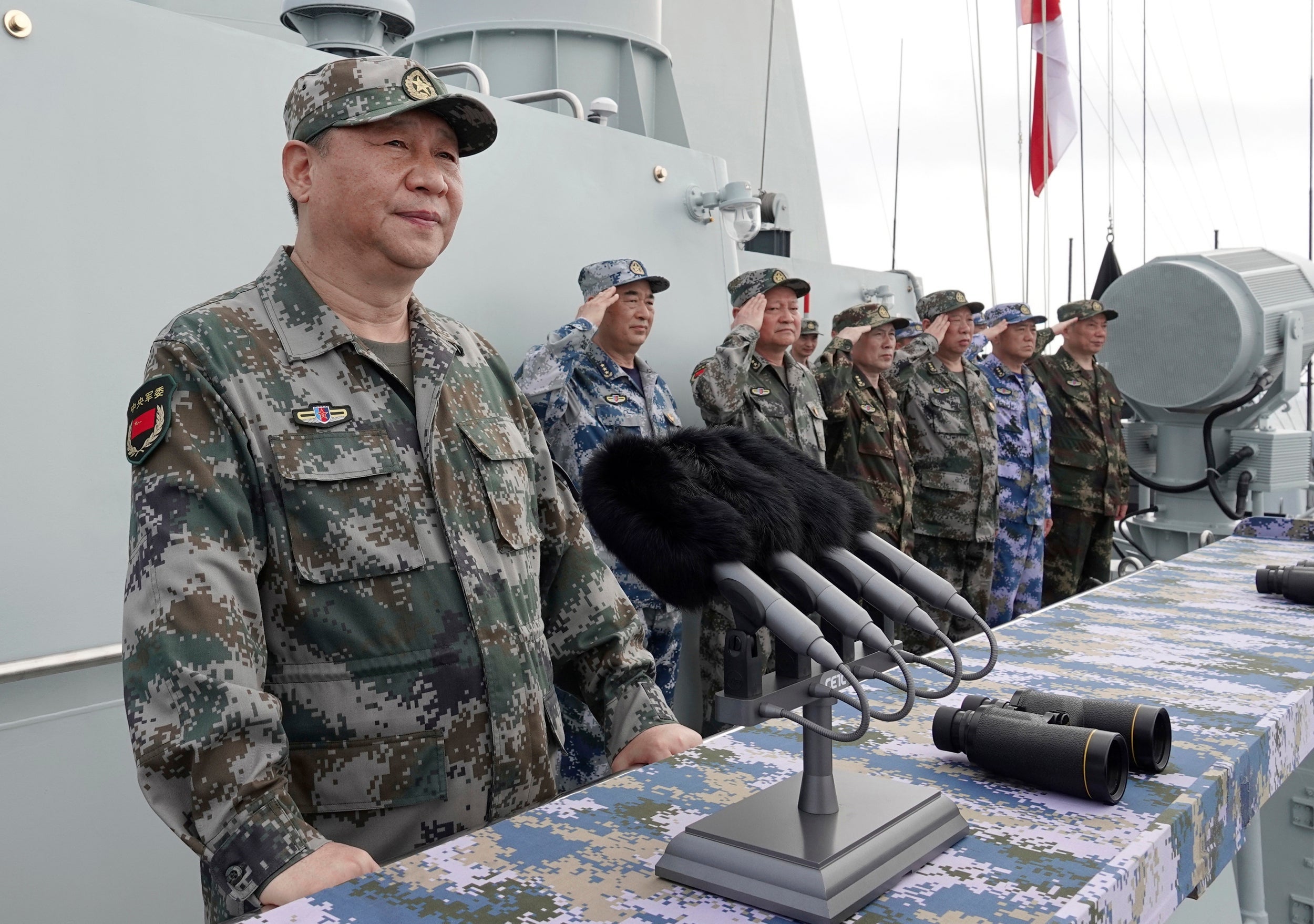 Xi Jinping speaks aboard a warship in the South China Sea. China says it is 'ready to go to war' in its efforts to reunify Taiwan and defeat 'separatists'