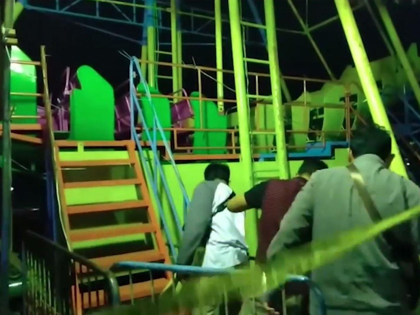 Investigators inspect a fairground ride following a fatal accident at a night market in Pekalongan, Central Java