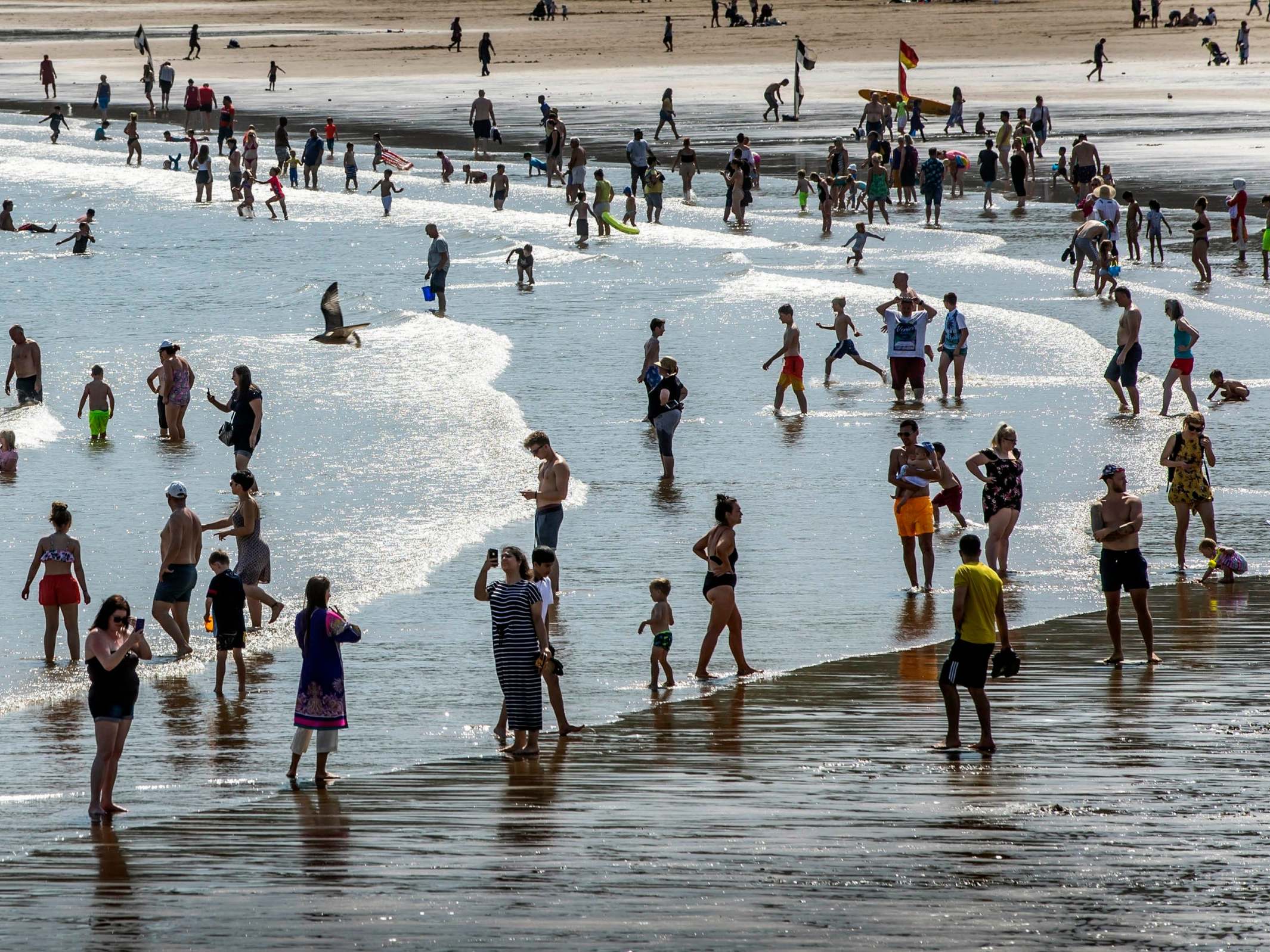 People enjoy the sun at Scarborough beach