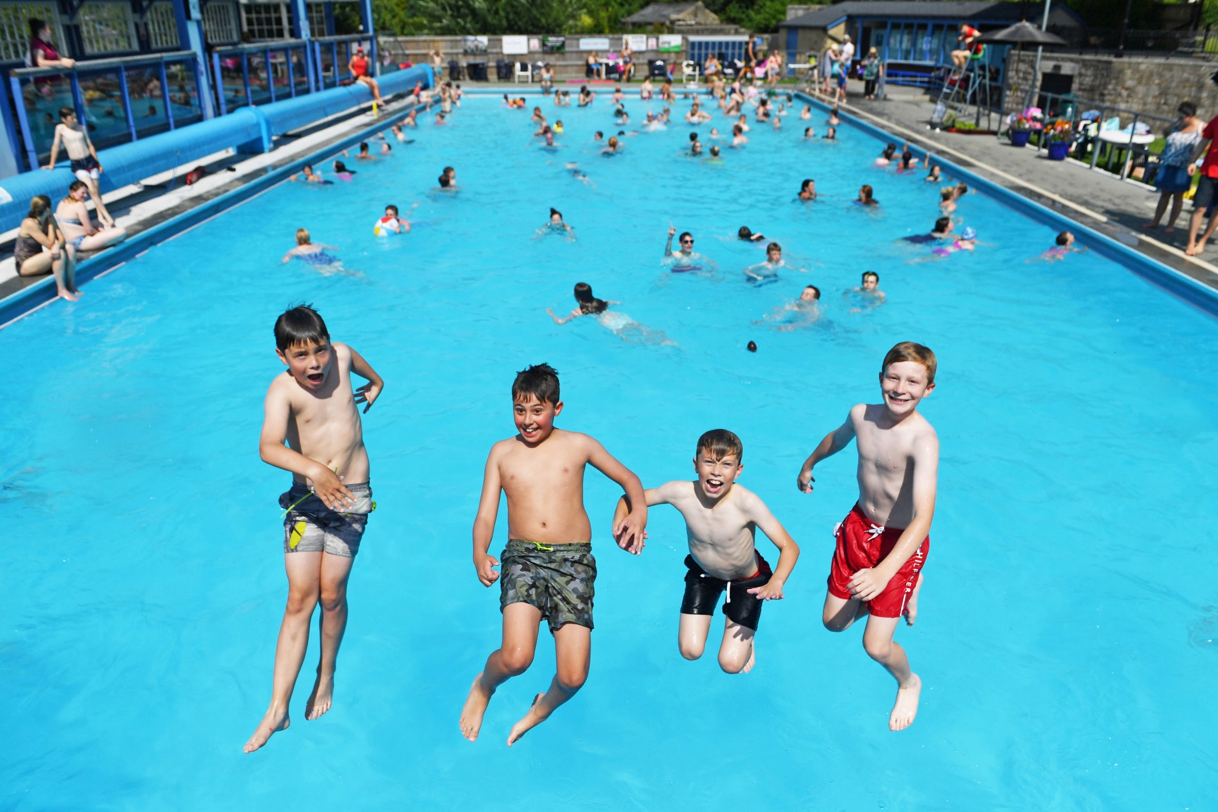 People play in the water at Hathersage Outdoor Swimming Pool
