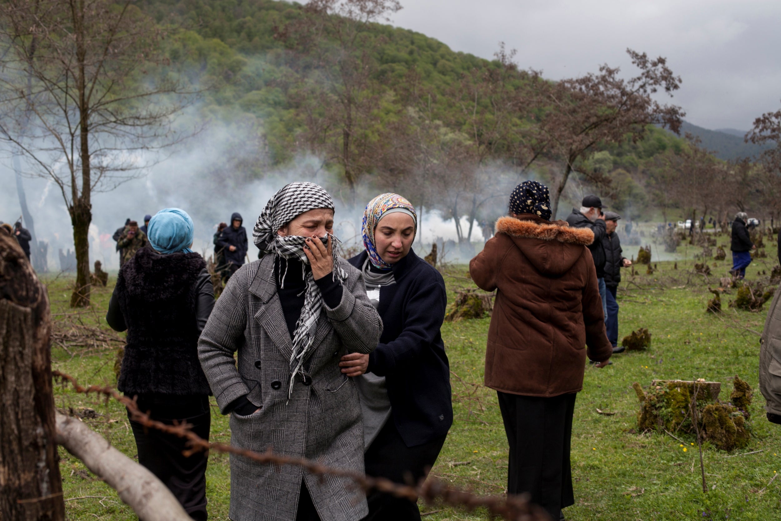 A woman covers her face during a rally held by residents of the Pankisi Gorge, who were protesting against the planned construction of a hydropower plant, near the village of Birkiani.