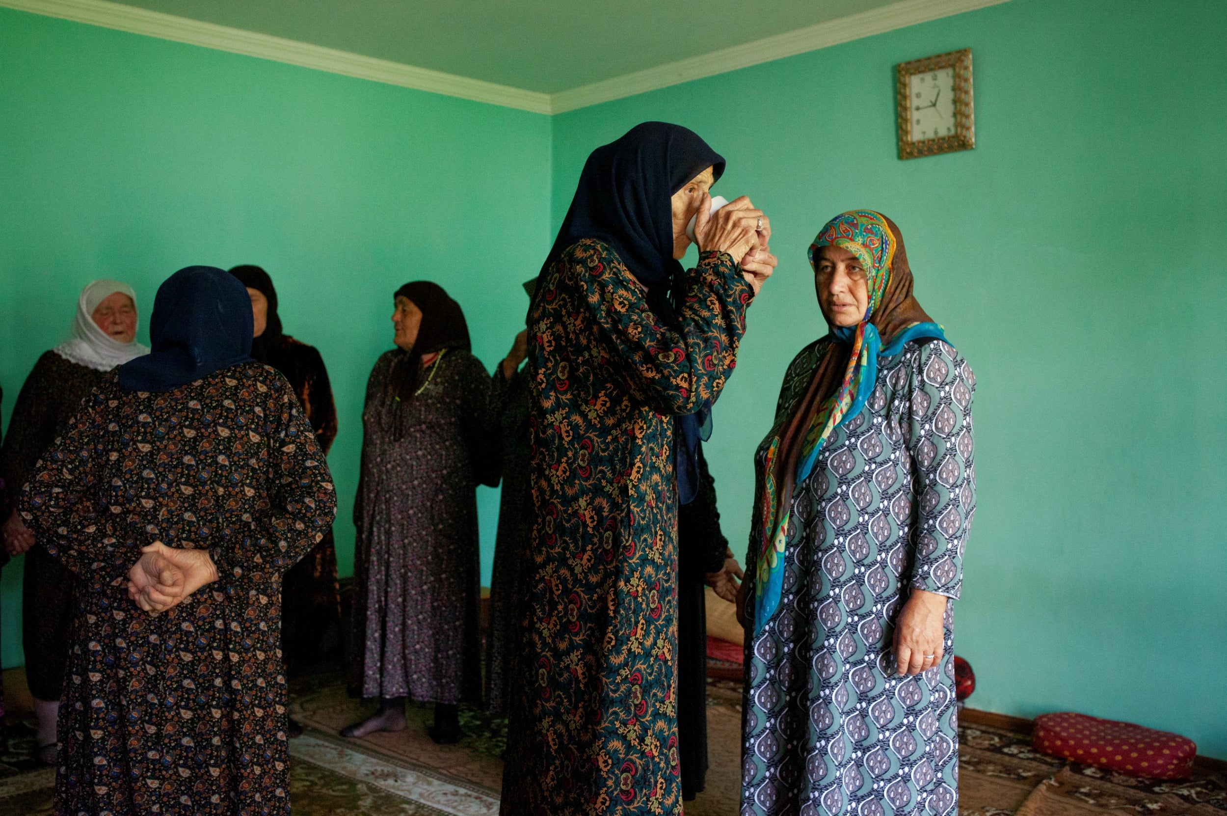 Women have a break after singing and dancing on a very hot day for a traditional Sufi ceremony, zikr, performed every Friday.