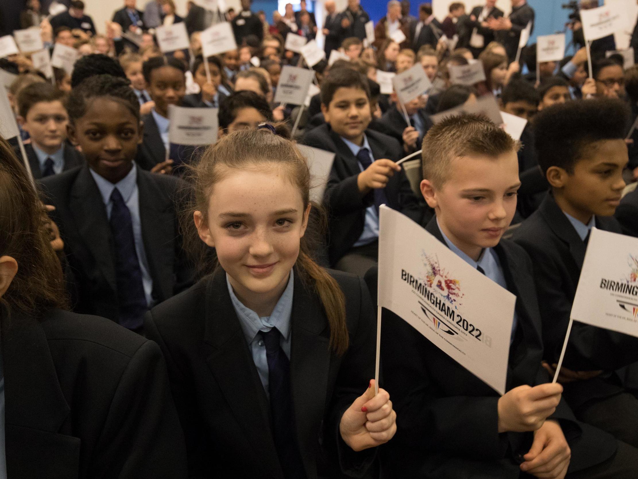 Students celebrate the announcement that Birmingham will host the 2022 Commonwealth Games (PA)