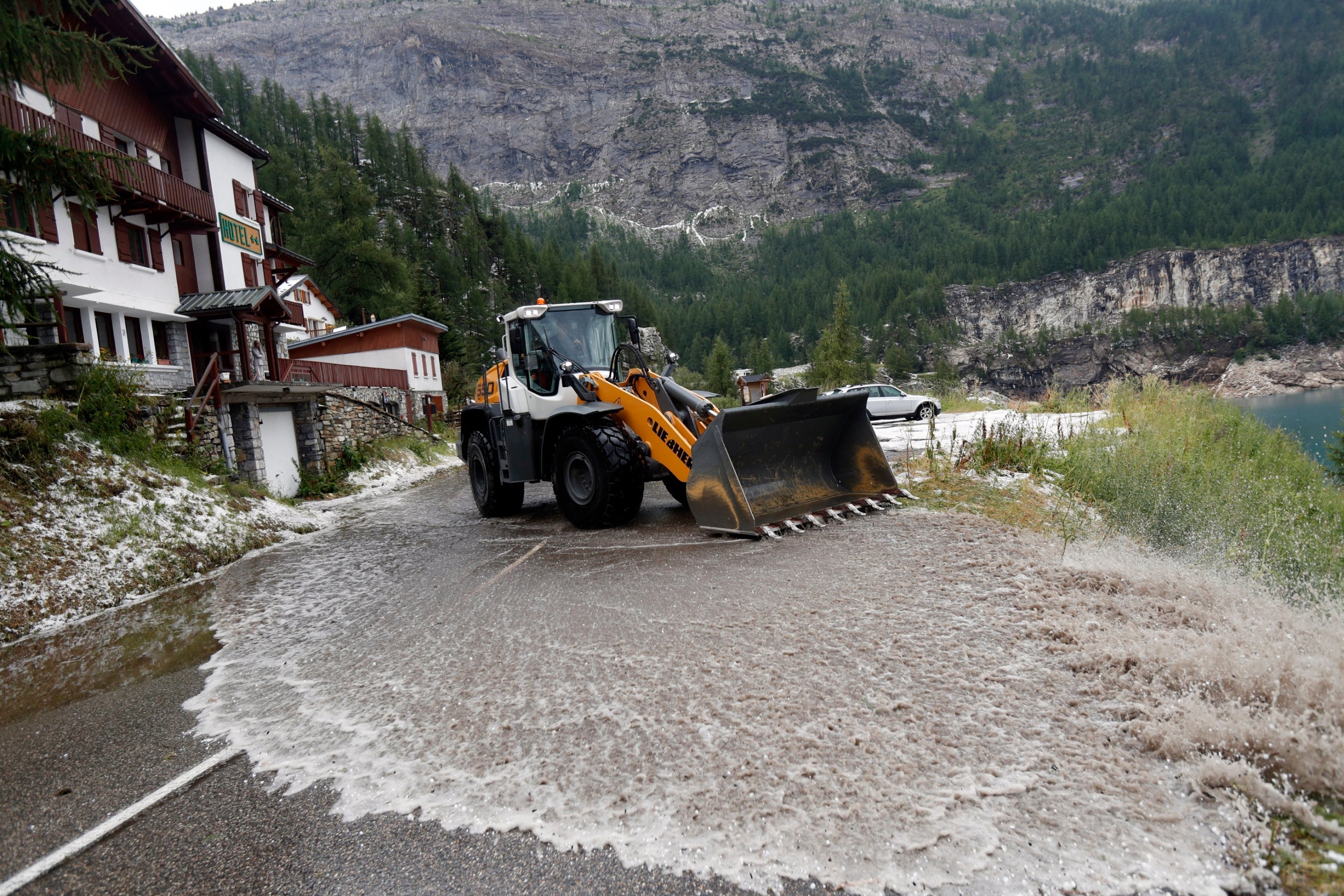 Water is cleared from the road on stage 19