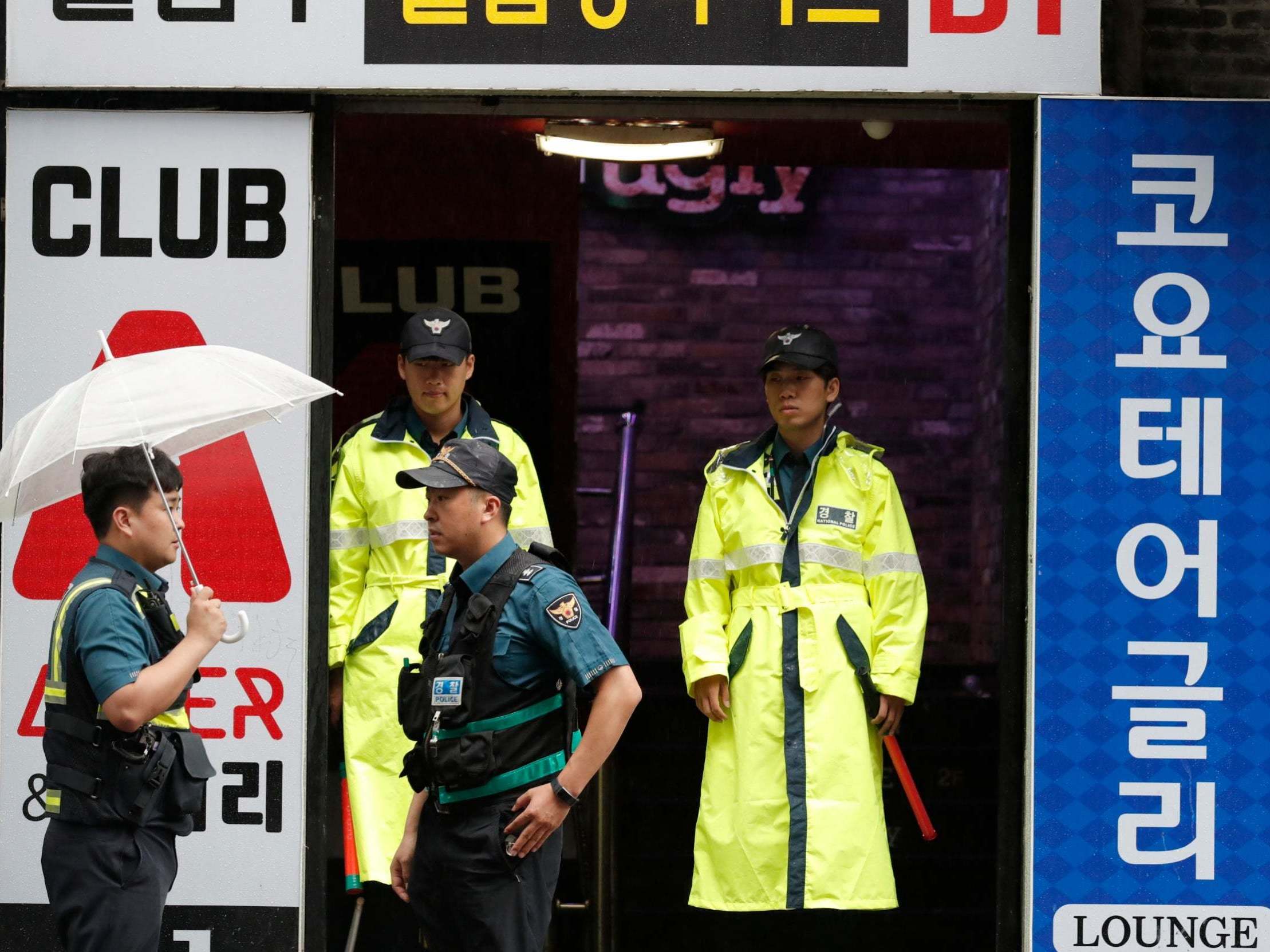 Police stand outside the Coyote Ugly nightclub in Gwangju, South Korea, after an internal balcony collapsed killing two people