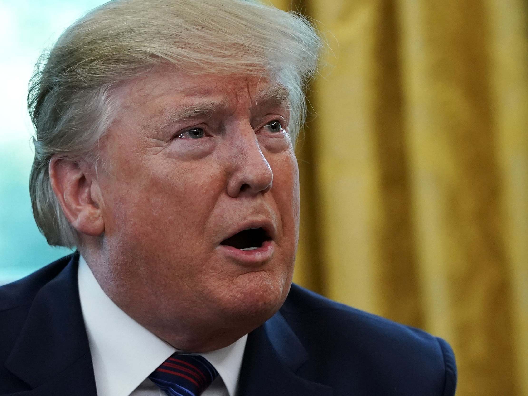 US President Donald Trump speaks to members of the press during a signing of a safe third country agreement in the Oval Office