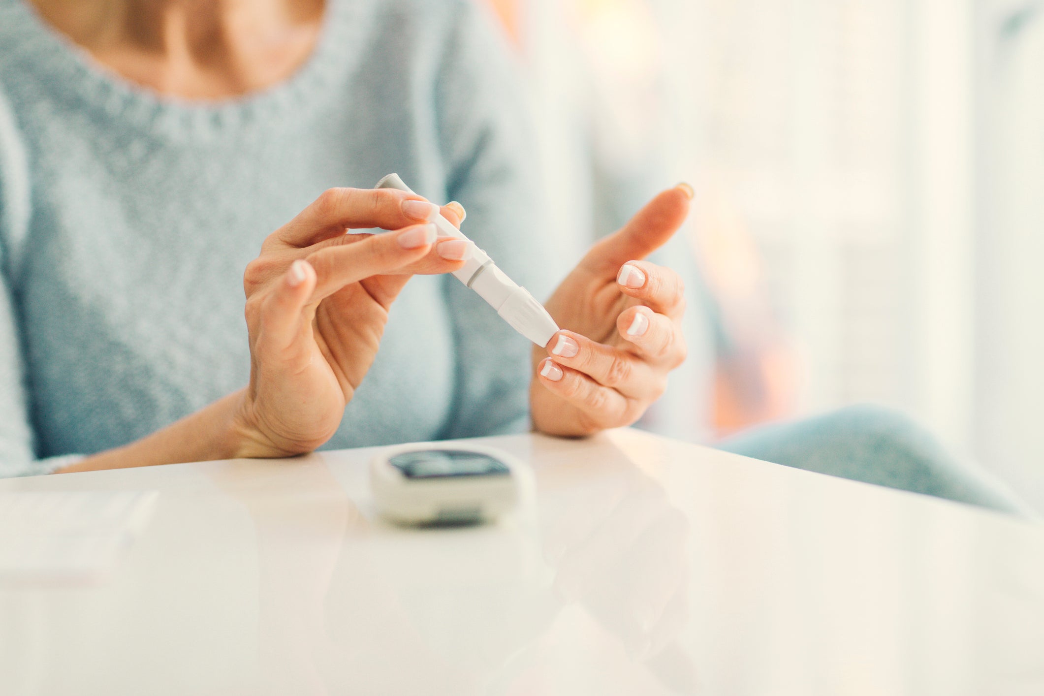 Mature Woman Doing Blood Sugar Test at home