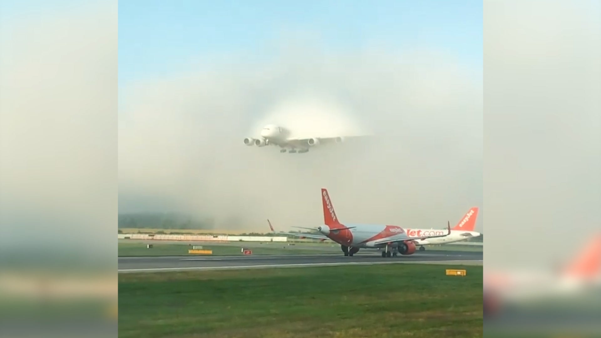 Watch this Emirates A380 burst through fog at Gatwick airport