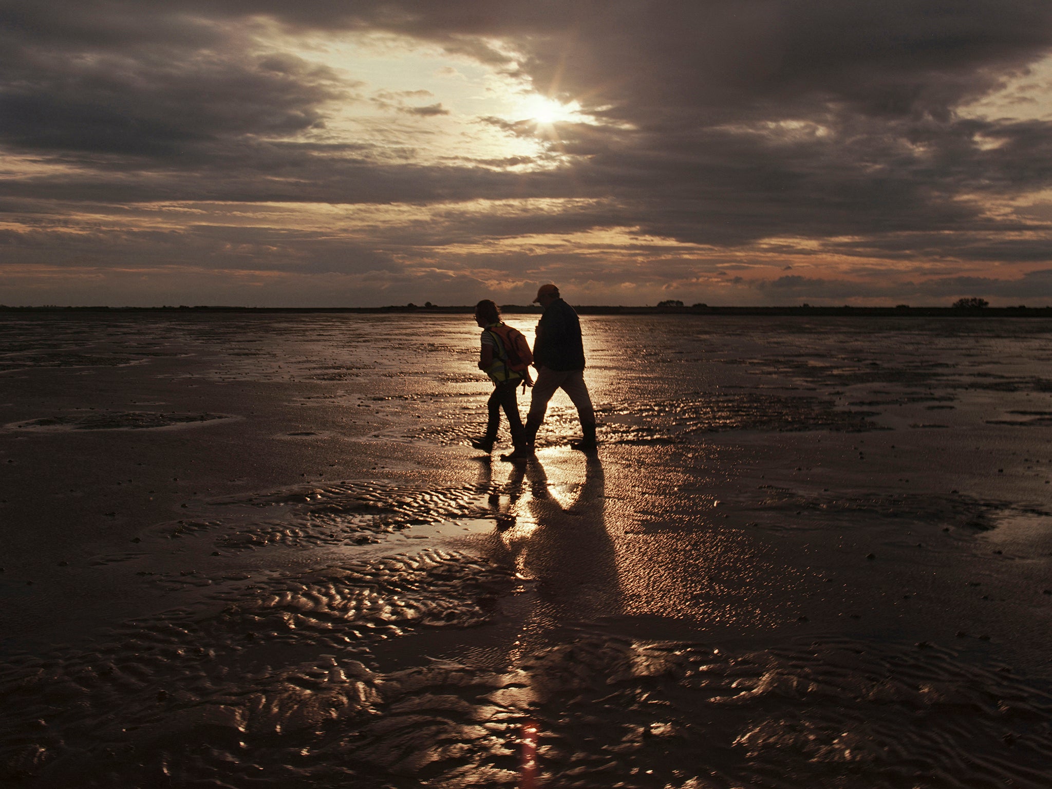 Toni Dawson, wife of guide Brian Dawson, and the writer head back before the tide comes in along the Broomway path