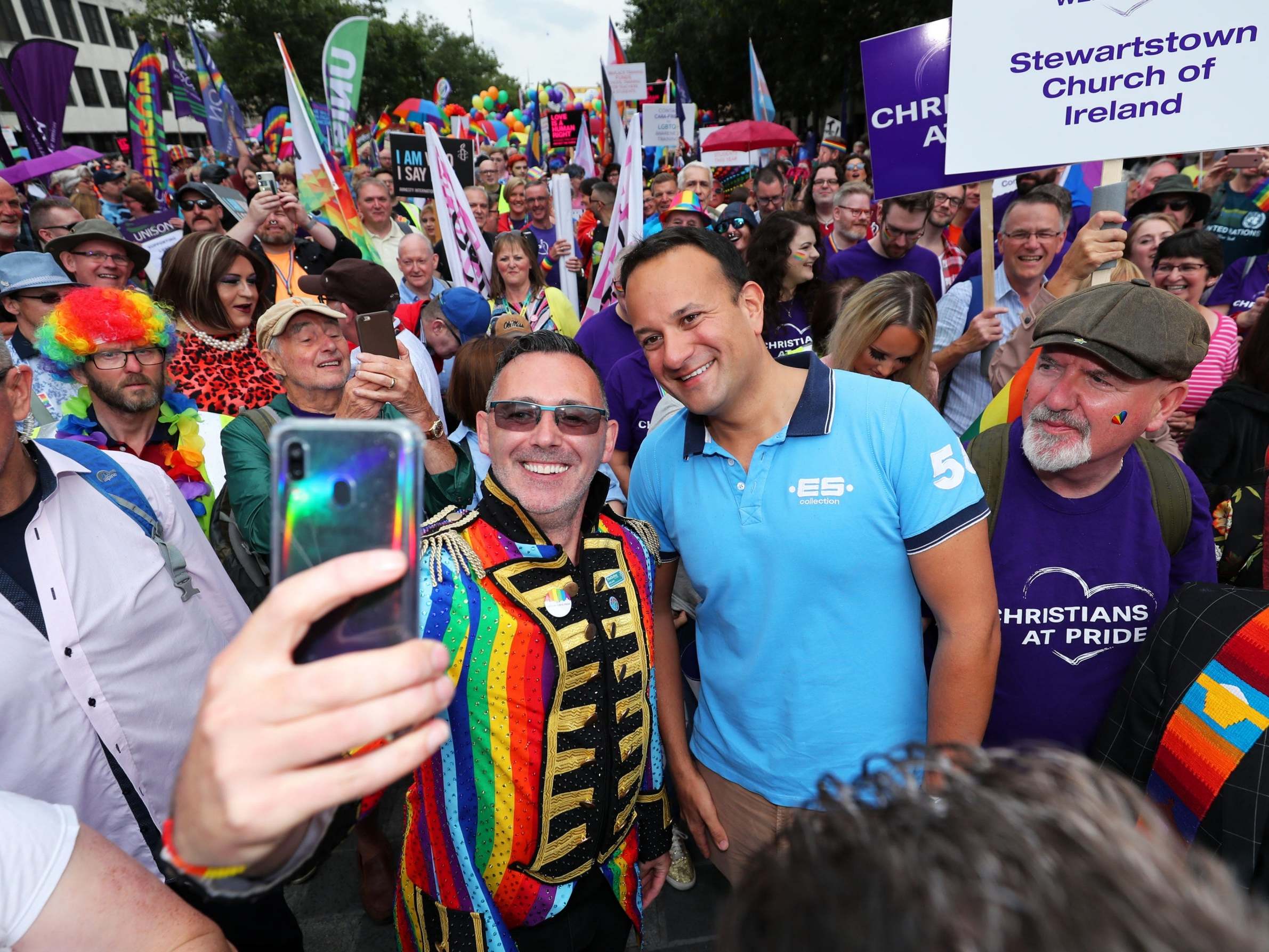 The taoiseach poses for a photo at the start of the parade in Belfast