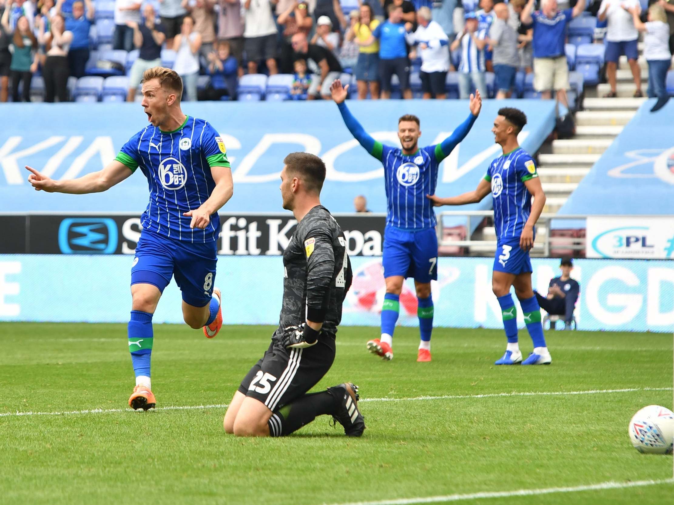 Wigan celebrate their third goal