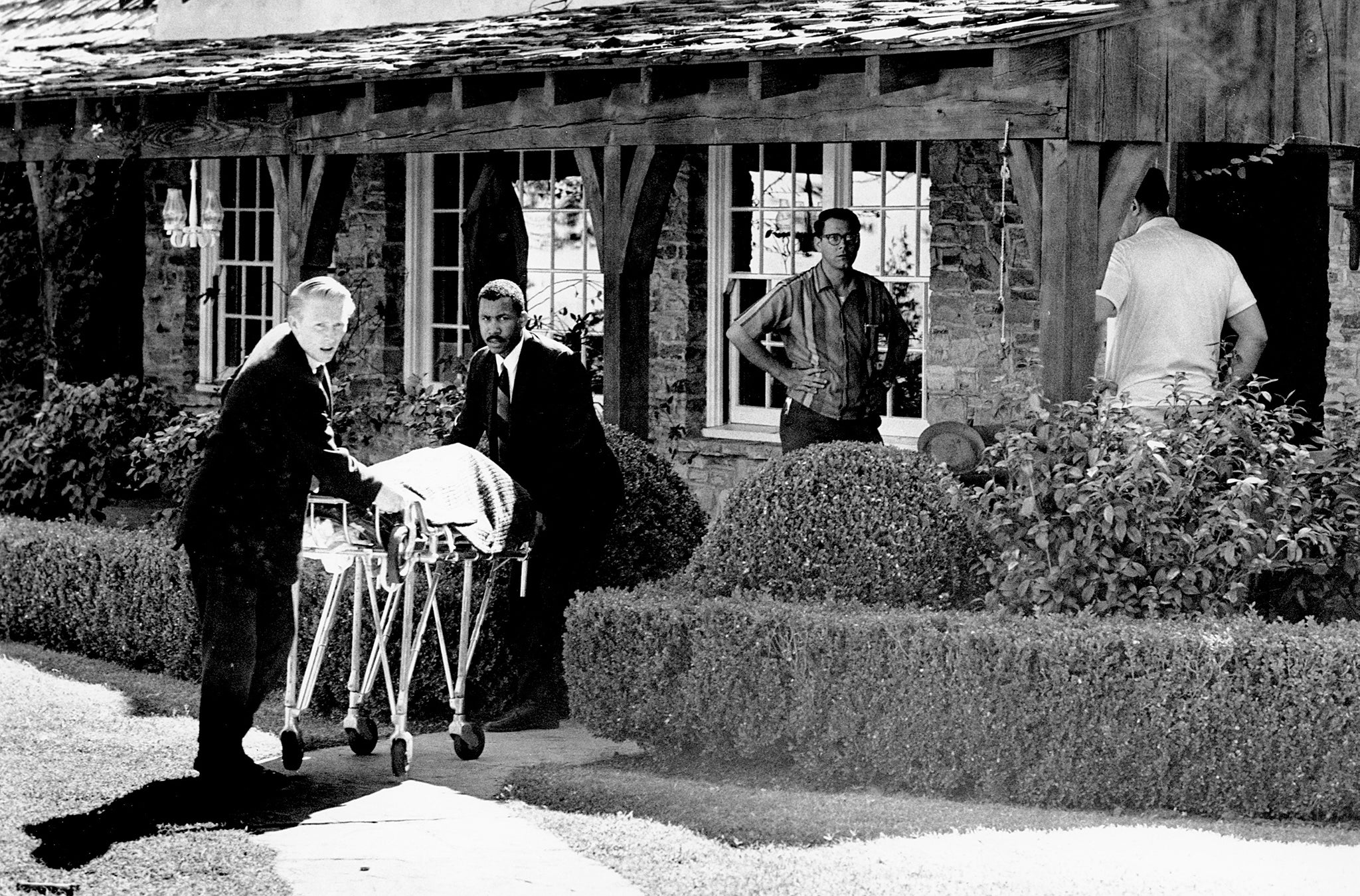 The body of actress Tate is removed from the rented house on Cielo Drive in Beverly Hills