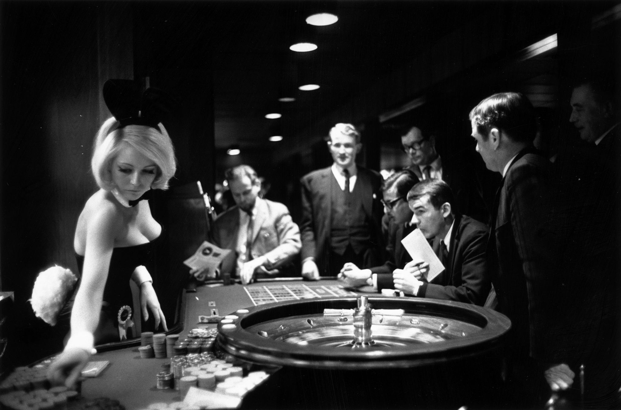 A bunny girl croupier at the Playboy club supervises a roulette wheel in 1967