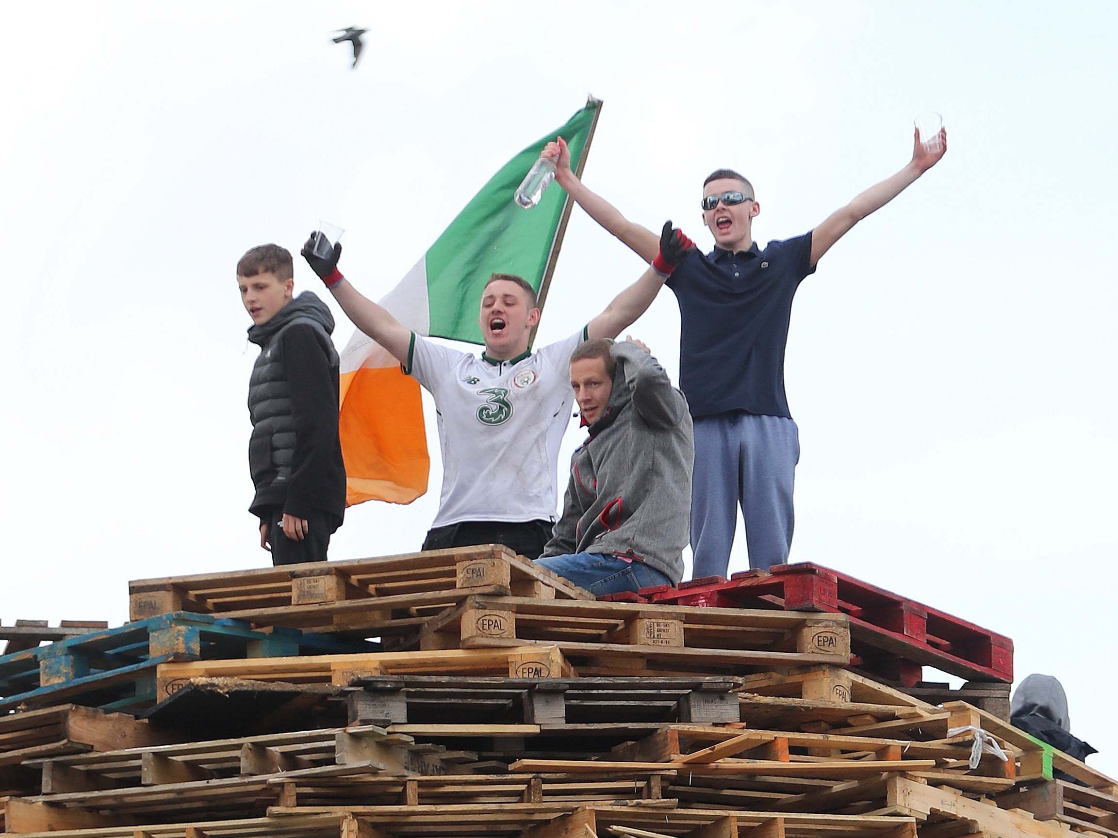 Youths at the site of a proposed bonfire in north Belfast, which contractors have been ordered to remove, 8 August 2019.
