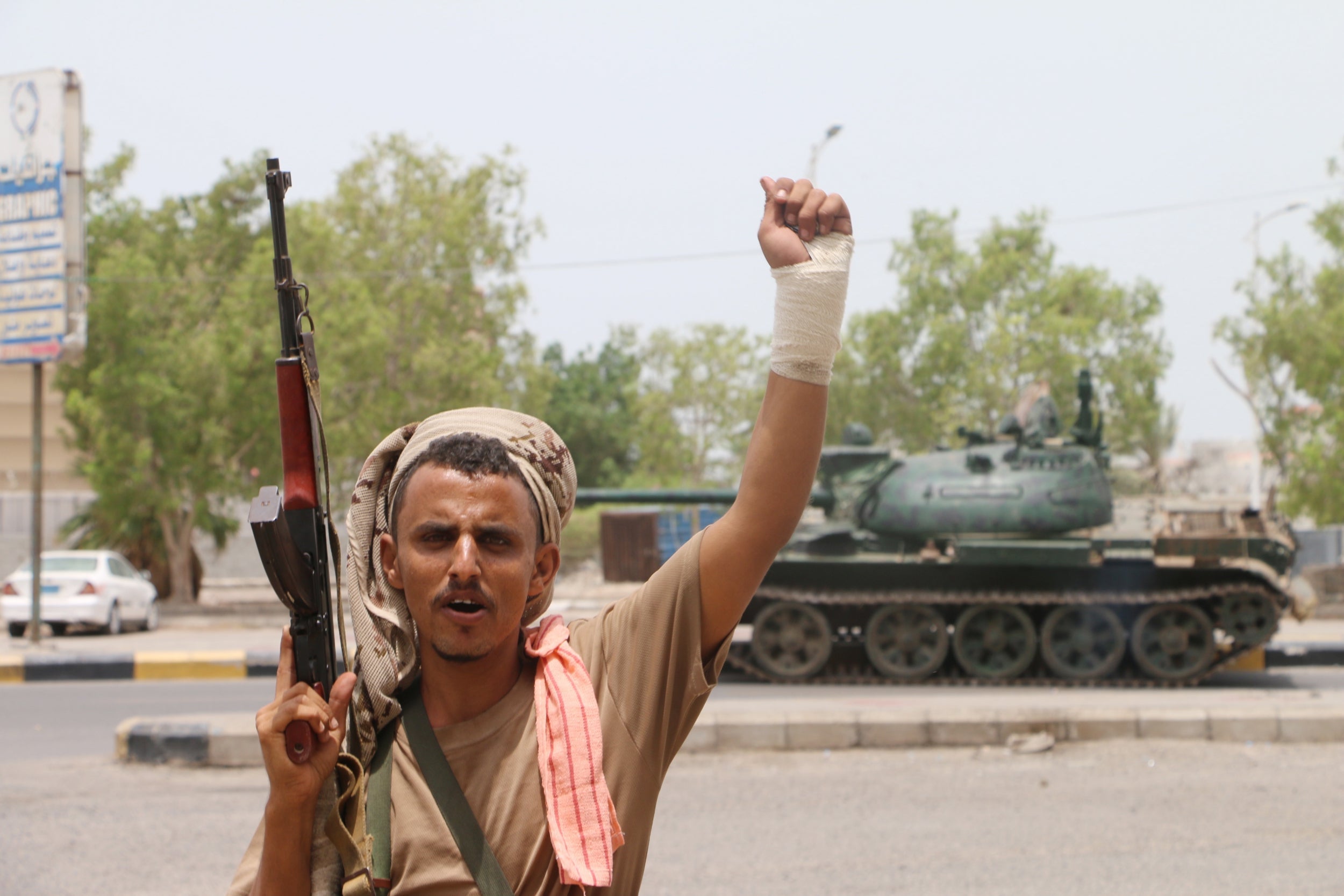 An armed member of a separatist southern group celebrates after seizing a military base during clashes with government forces in Aden, Yemen